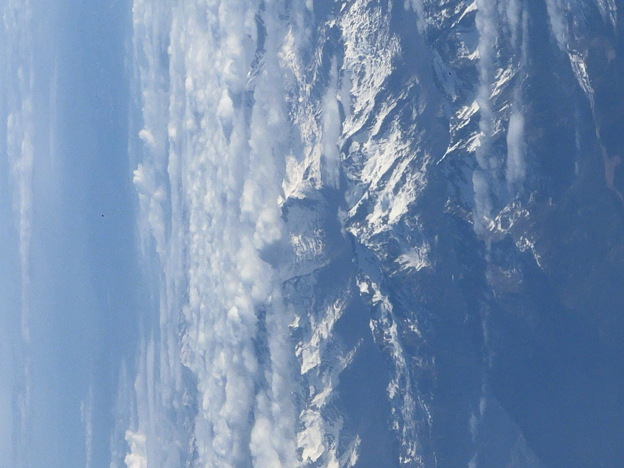Aerial view captures snow-capped Dolomites peaks in clear skies