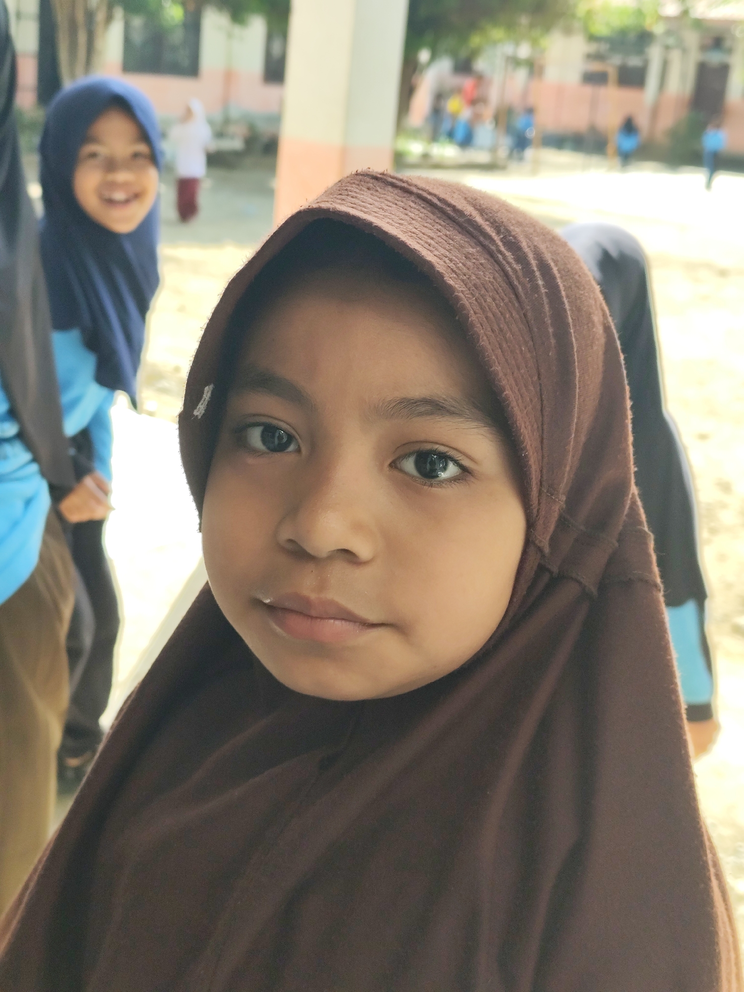 Kids at a school or community gathering, snacks and uniforms in view
