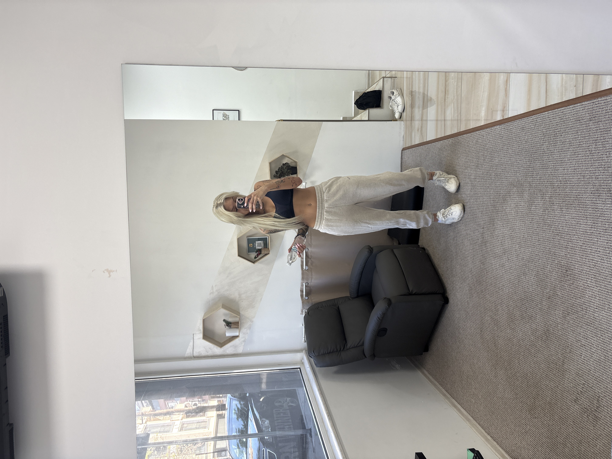 Woman takes mirror selfie in athletic wear in Plovdiv