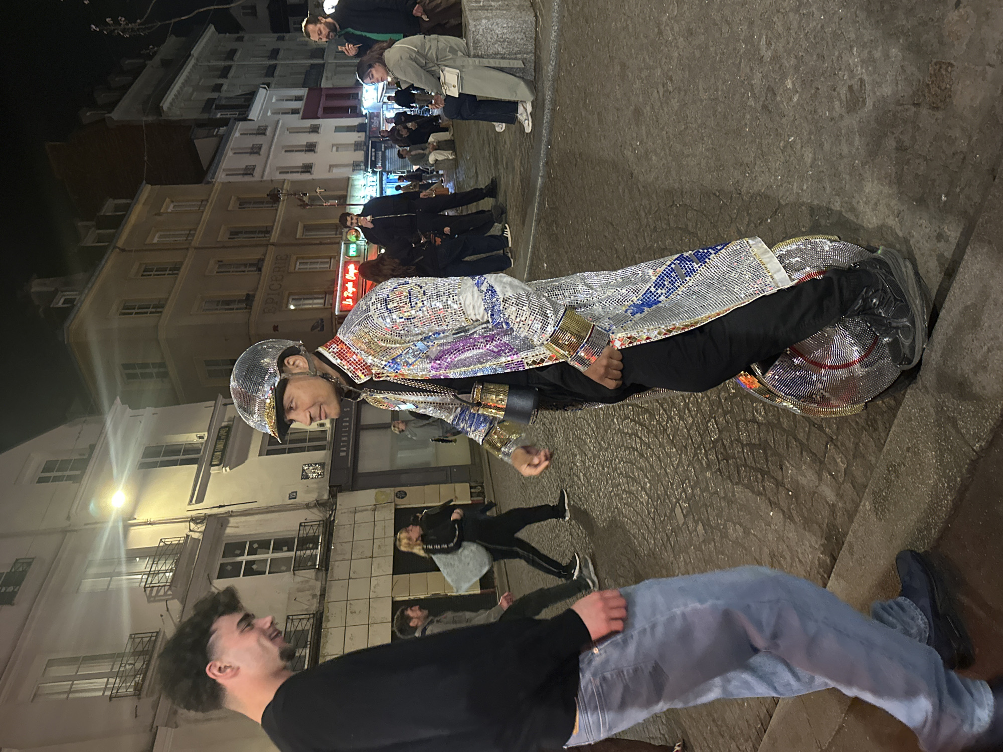 Disco-suited performer rides motorized unicycle through Paris streets