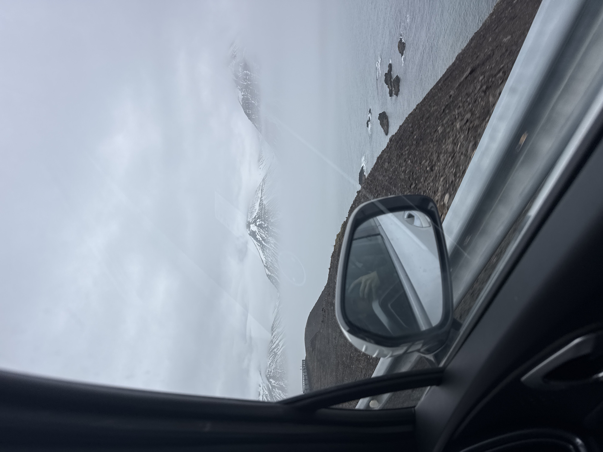 Traveler captures misty Iceland coastal views from vehicle