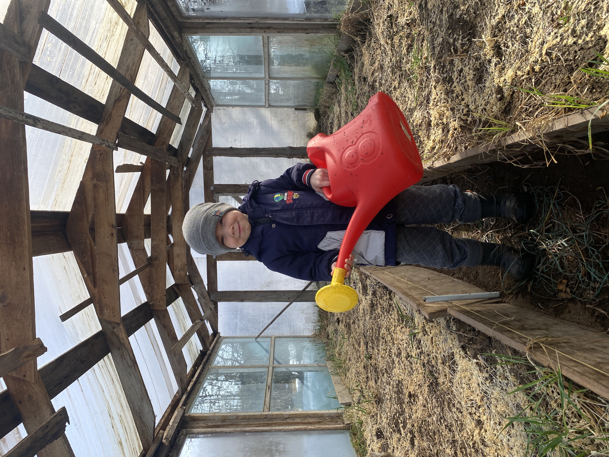 Child spotted with watering can, balance bike in Ольховка