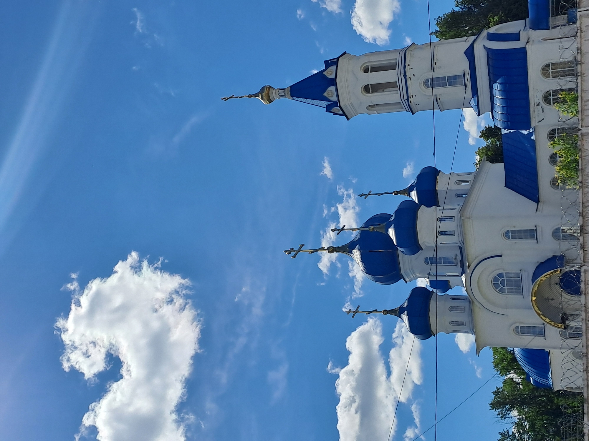 Orthodox church, commercial truck observed in Yalga, Russia morning