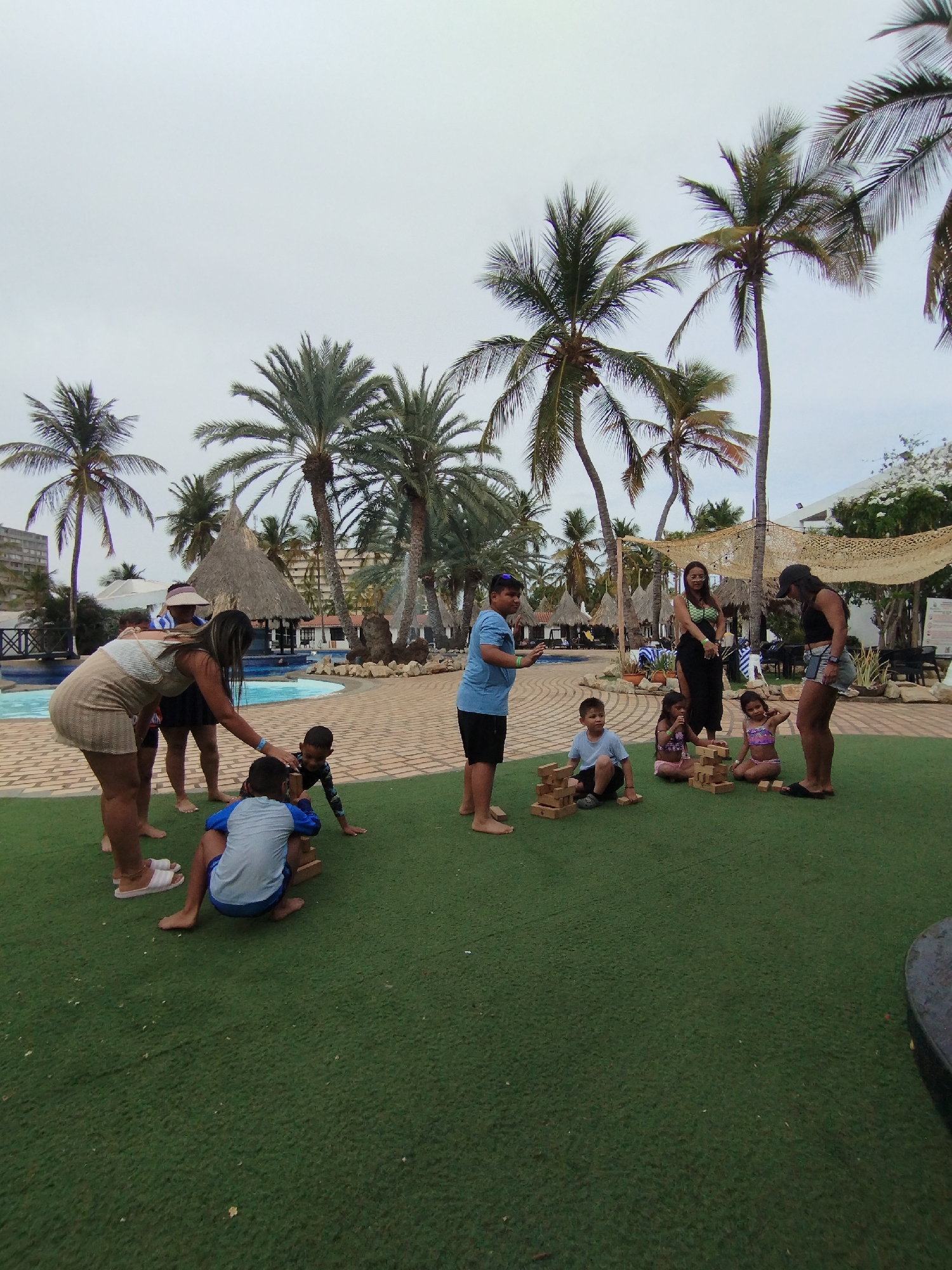 Families play Jenga at Venezuelan resort poolside gathering