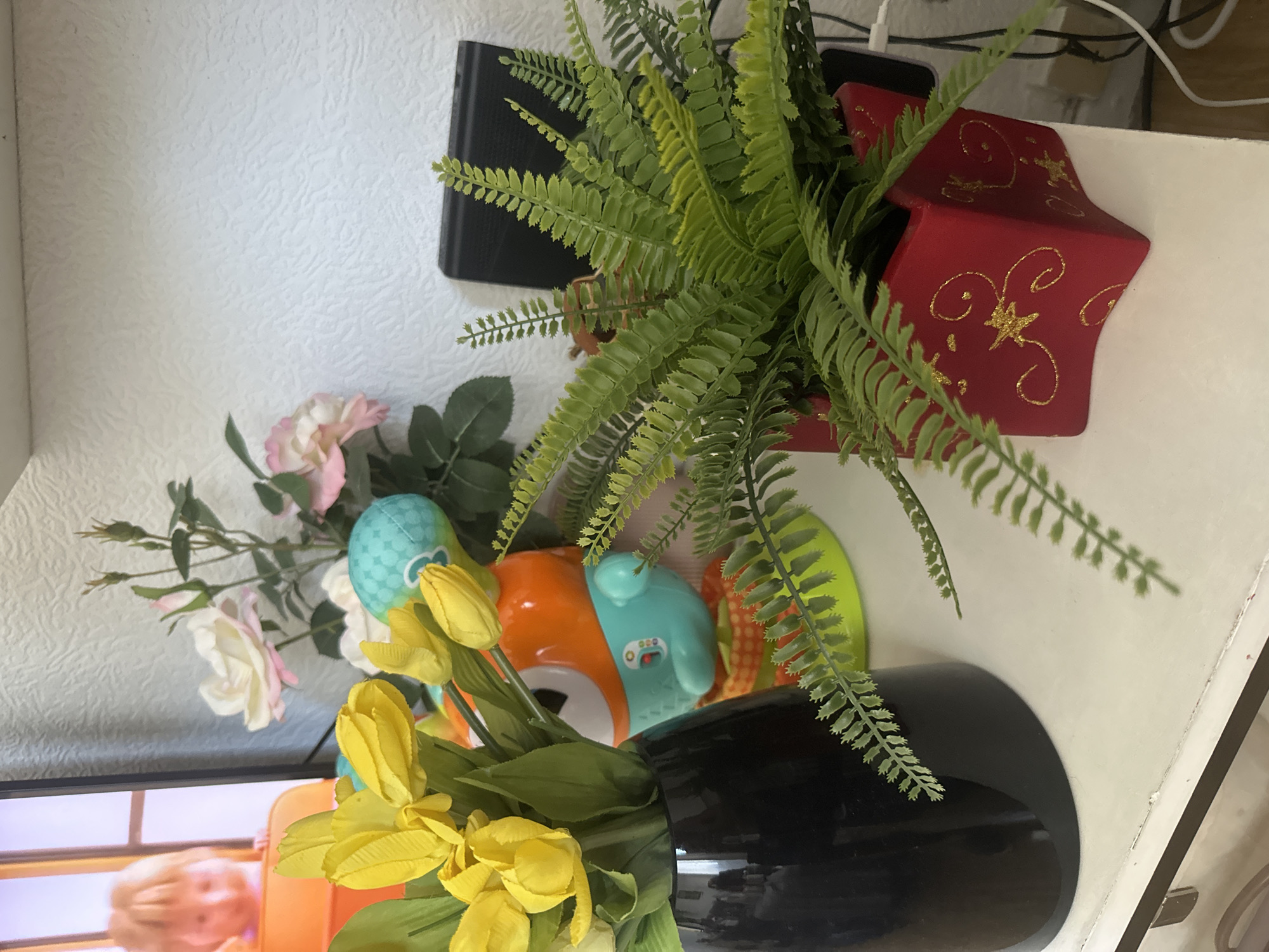Home display with artificial flowers and baby toys documented Strasbourg