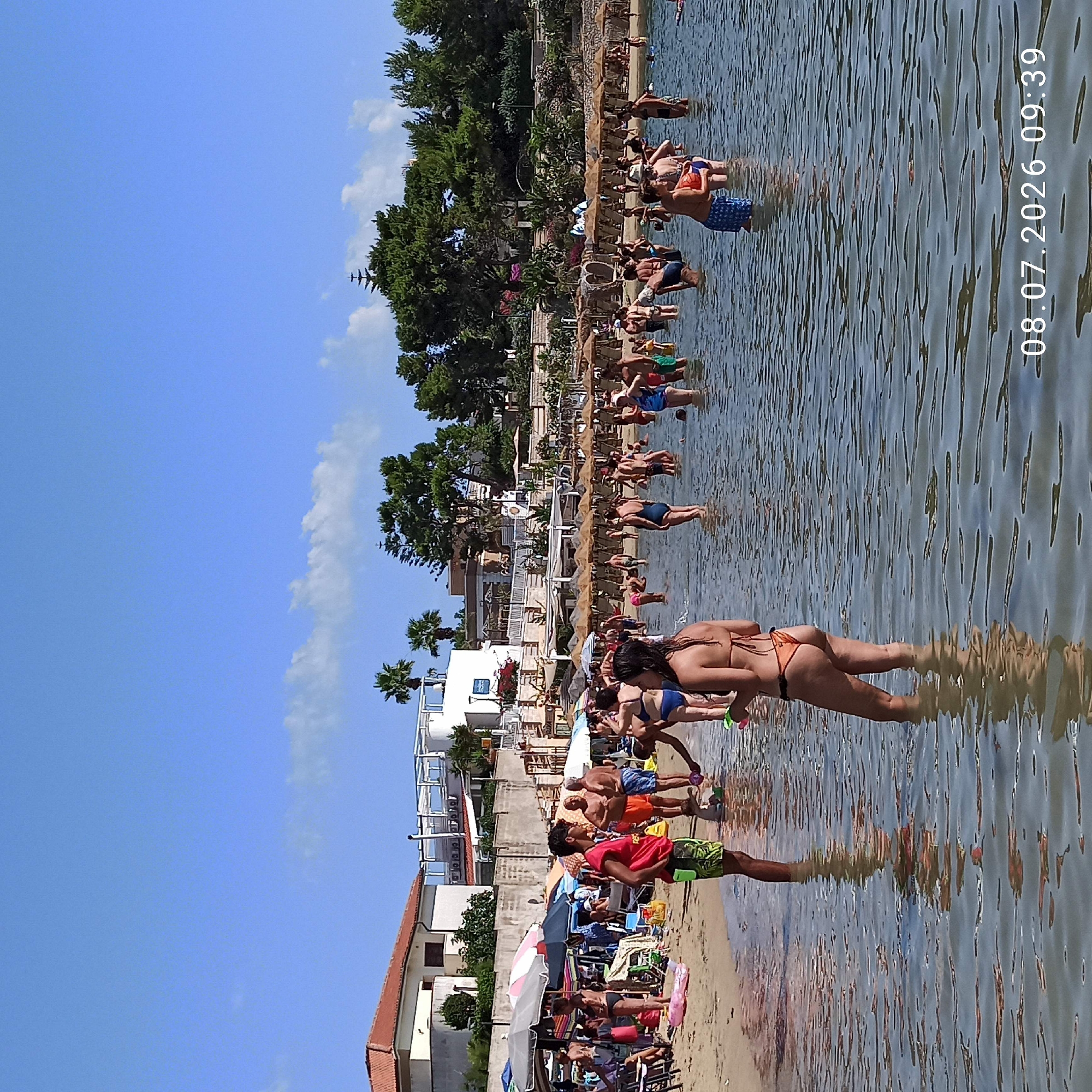 Crowded summer beach day on the Adriatic coast in Trani