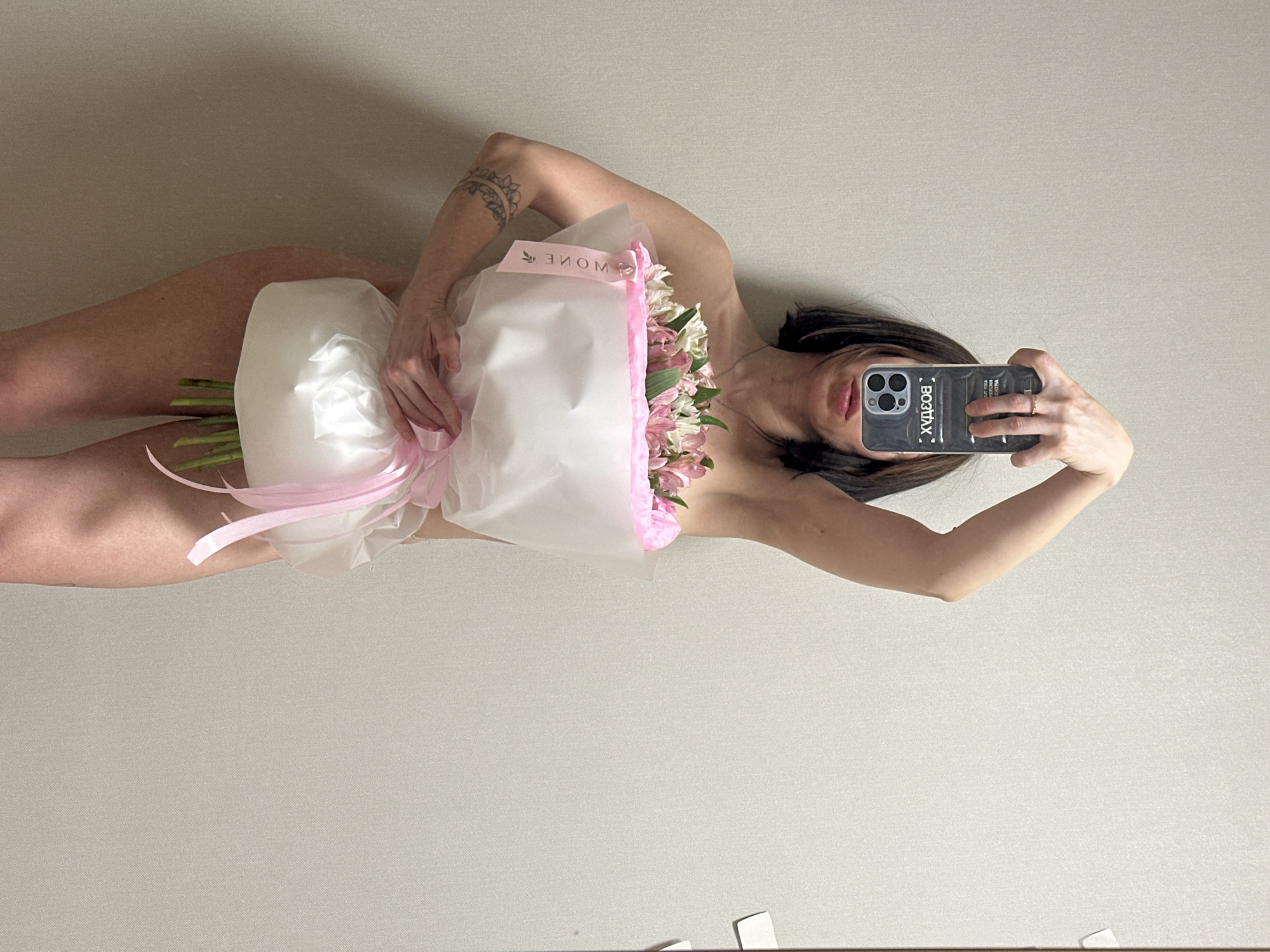 Person takes multiple selfies with flowers in Votkinsk apartment