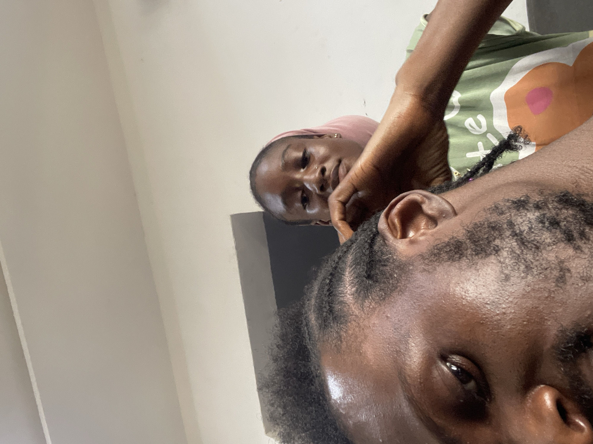 Hair braiding session and selfies in an Abuja home