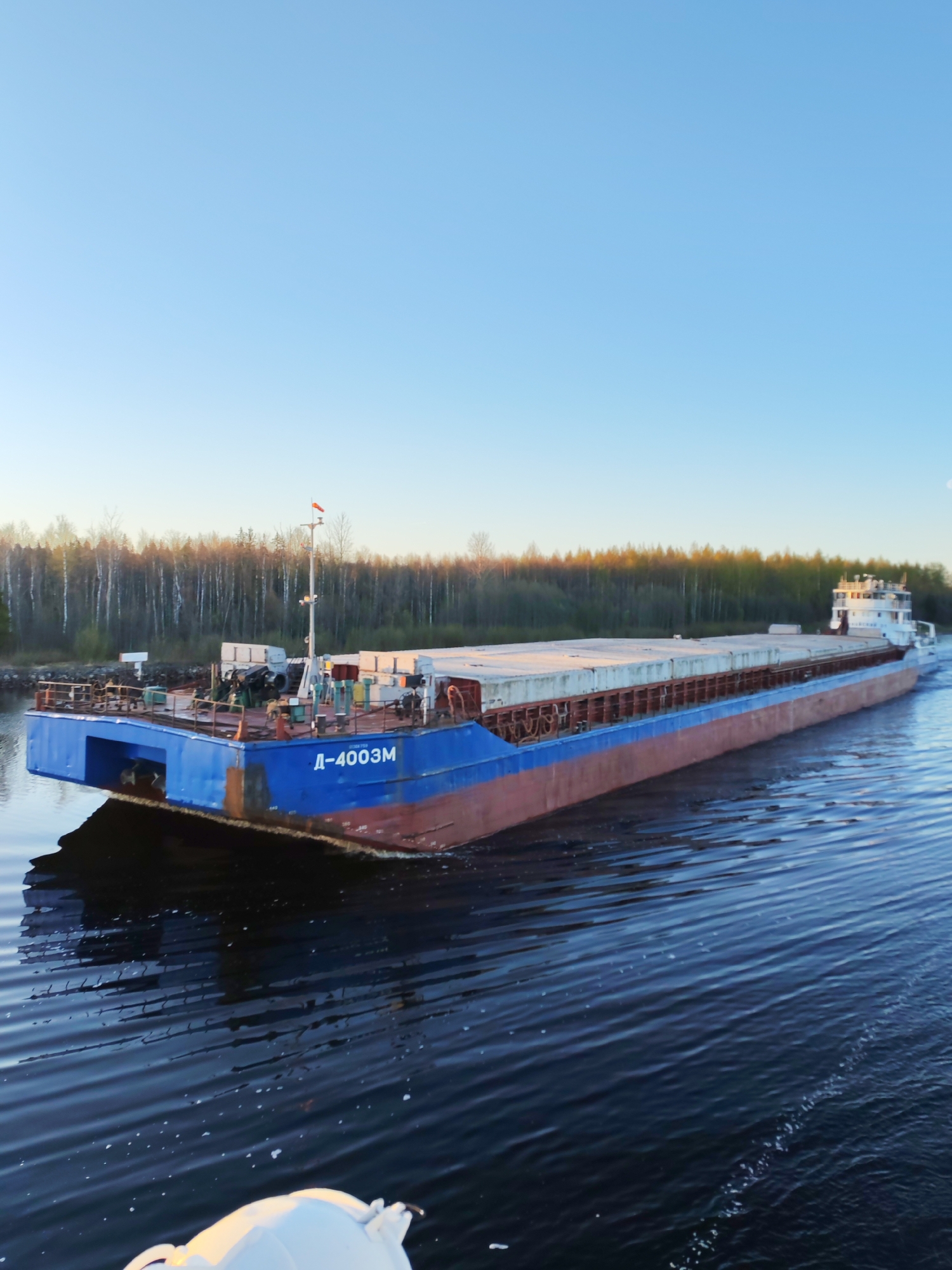 Cargo barge transport operation observed on Russian river