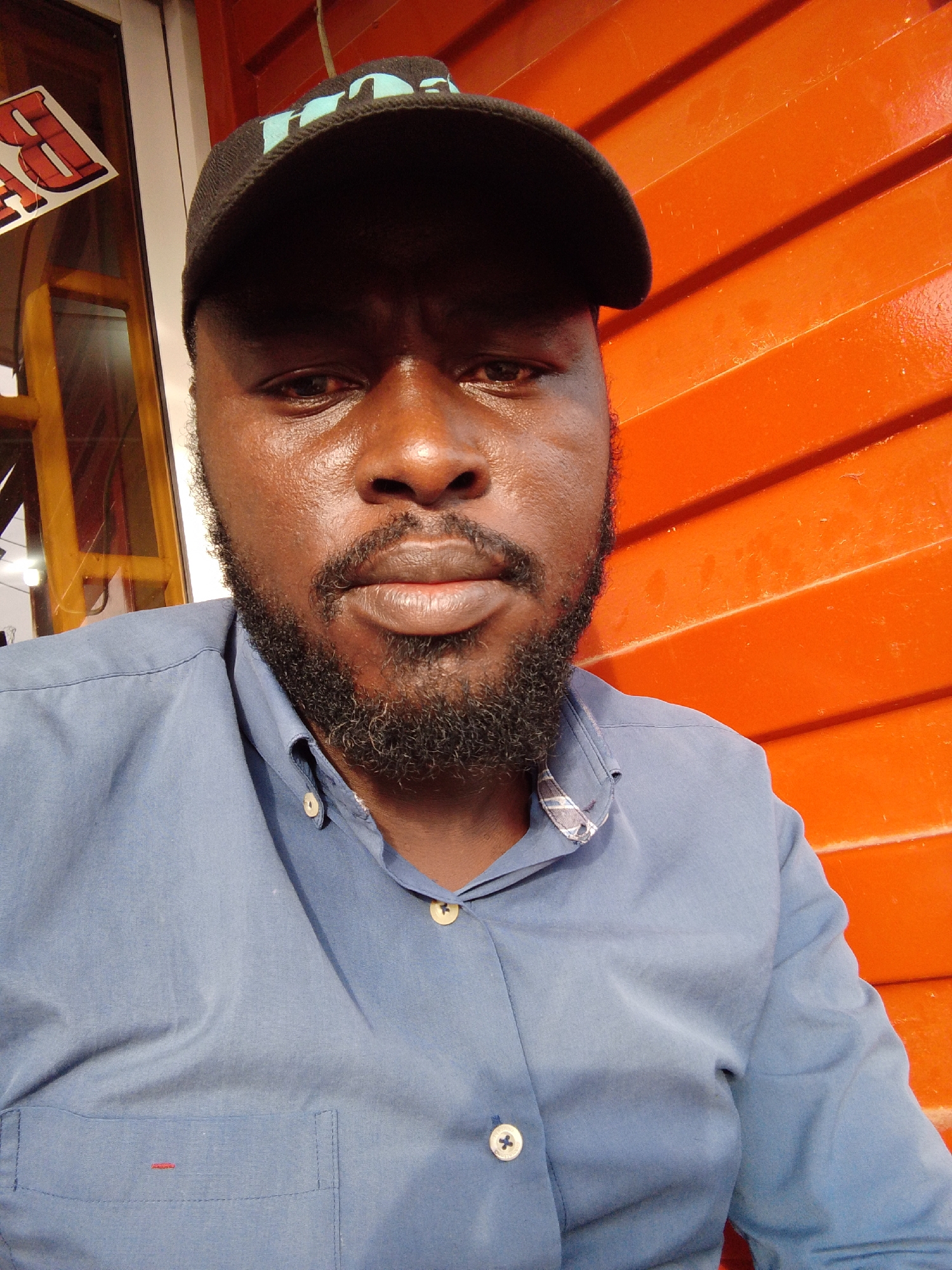 Portrait of bearded man in black cap photographed in Jos