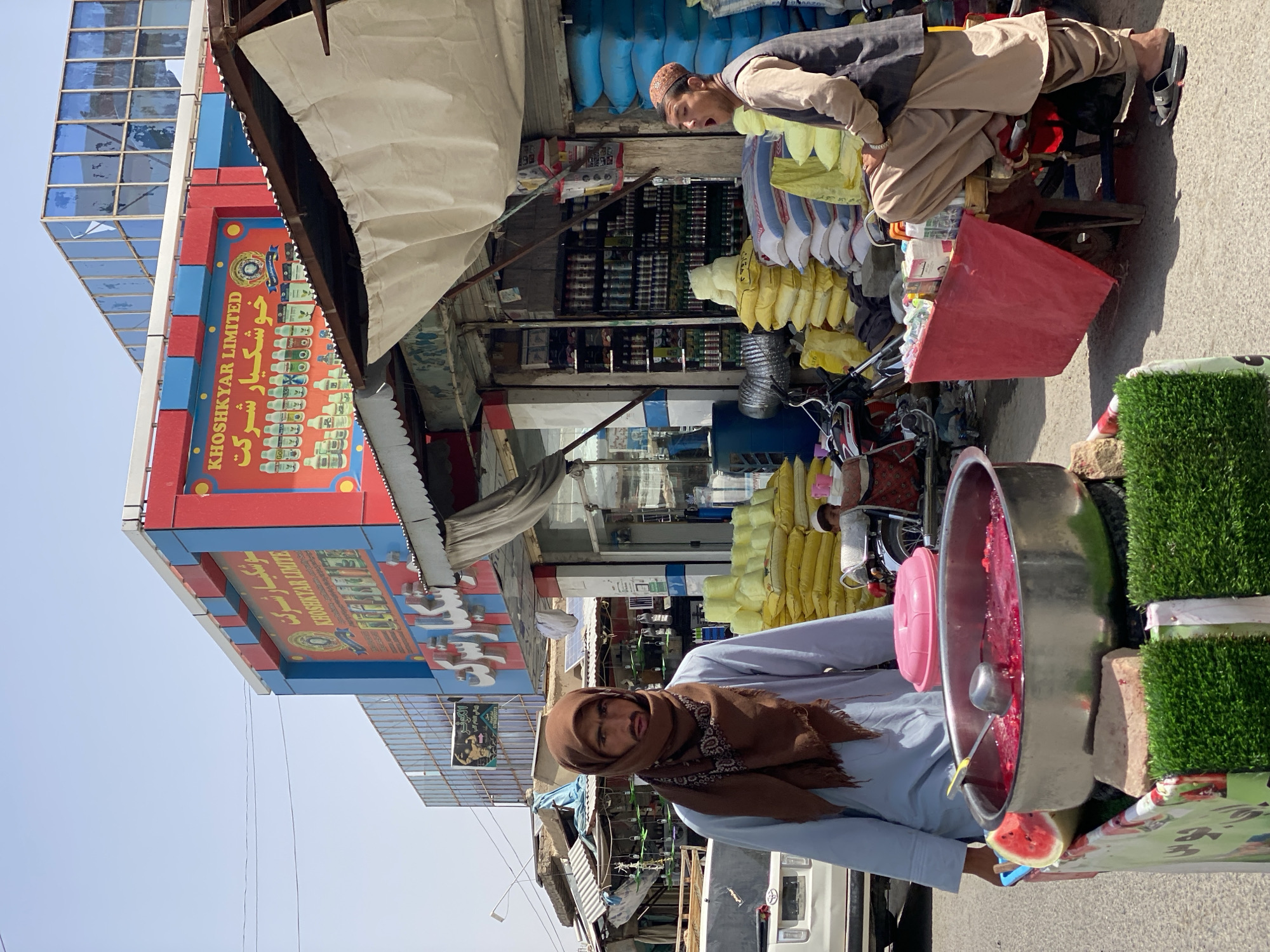 Street vendor mixes a red drink in Kandahar
