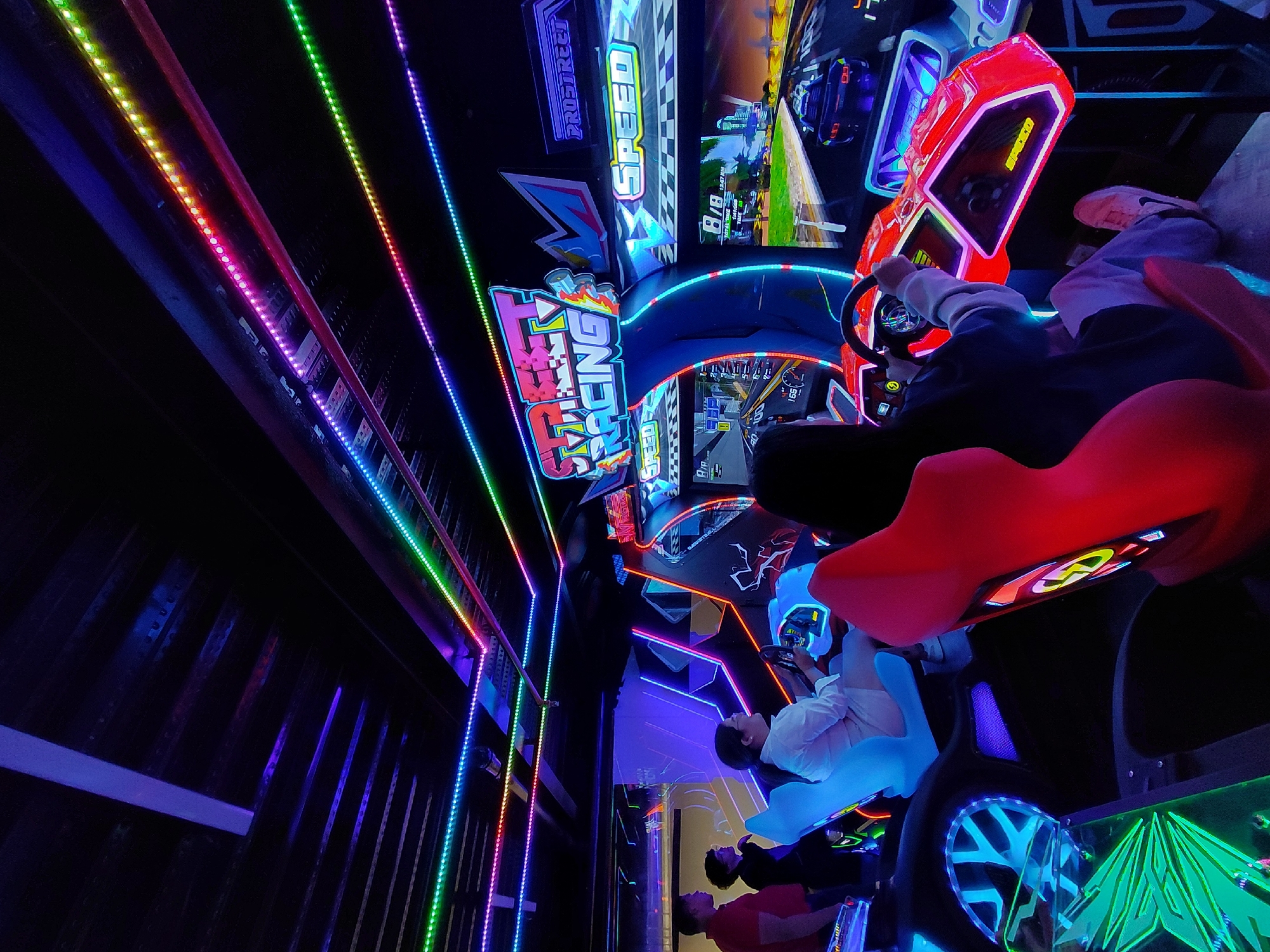 Neon-lit arcade gaming session in Pampatar, Venezuela