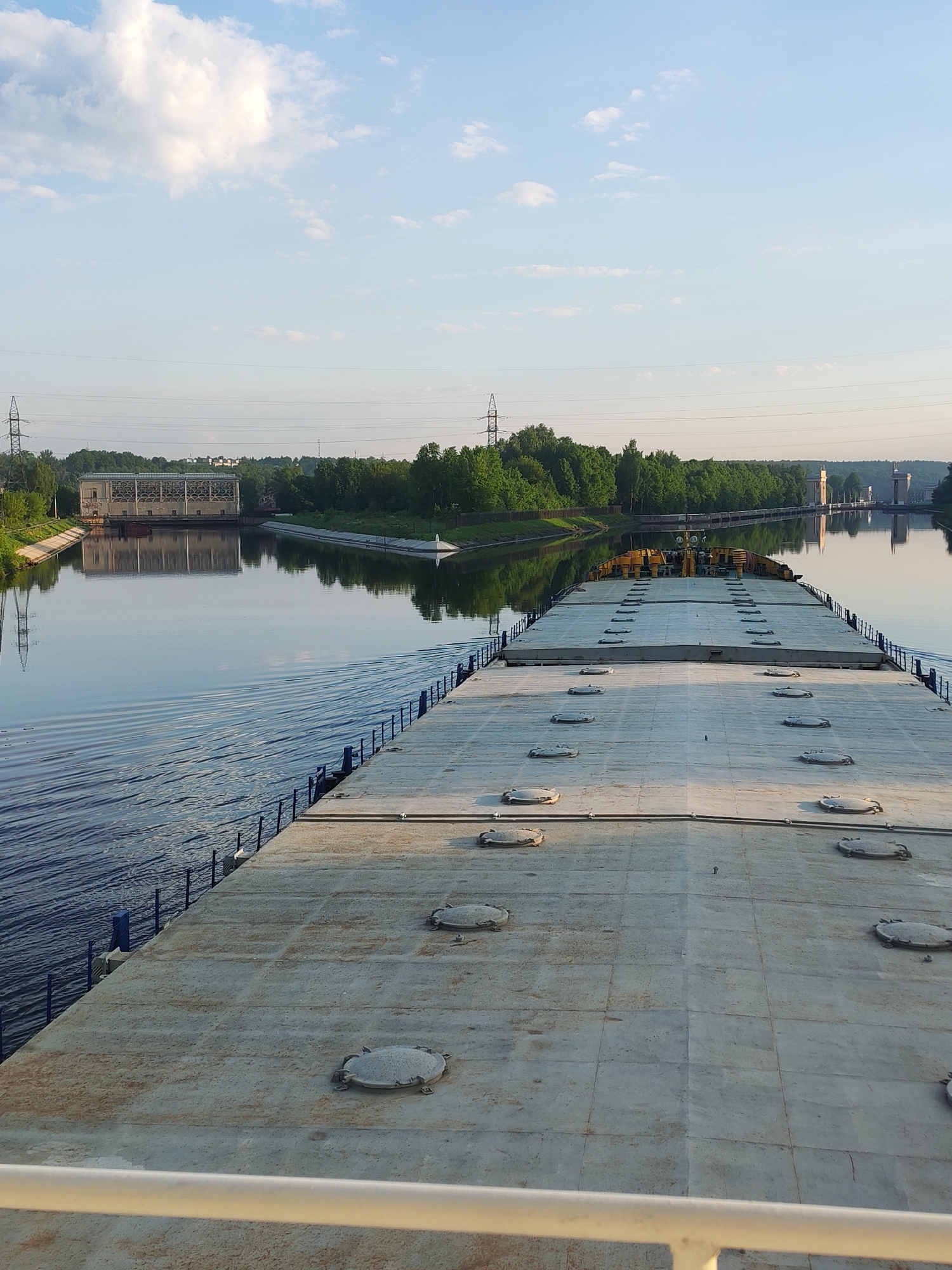 Barge navigates Russian waterways near Ermolino settlement at dawn