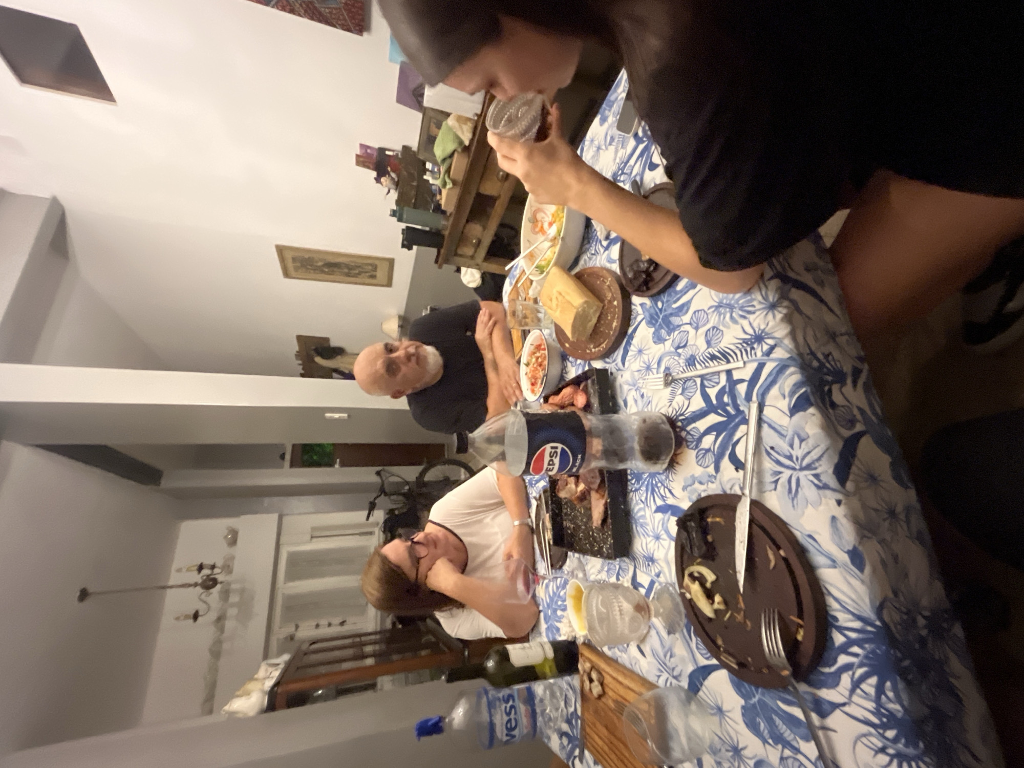 Woman drinks from cup at dining table in Avellaneda