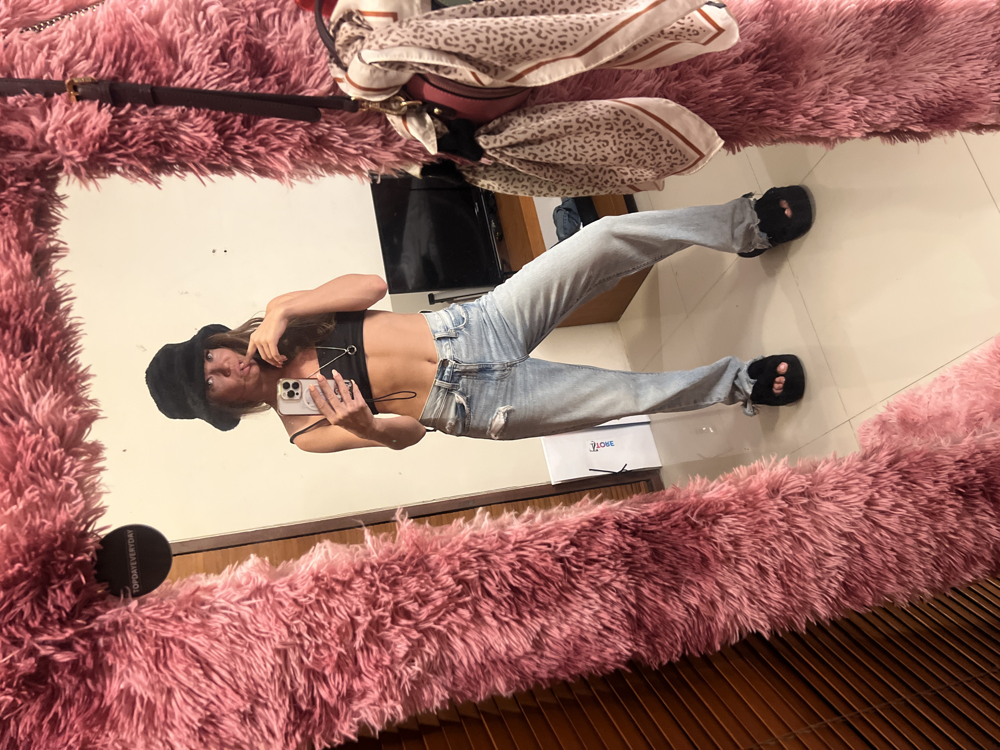 Woman takes mirror selfie in pink frame, North Kuta