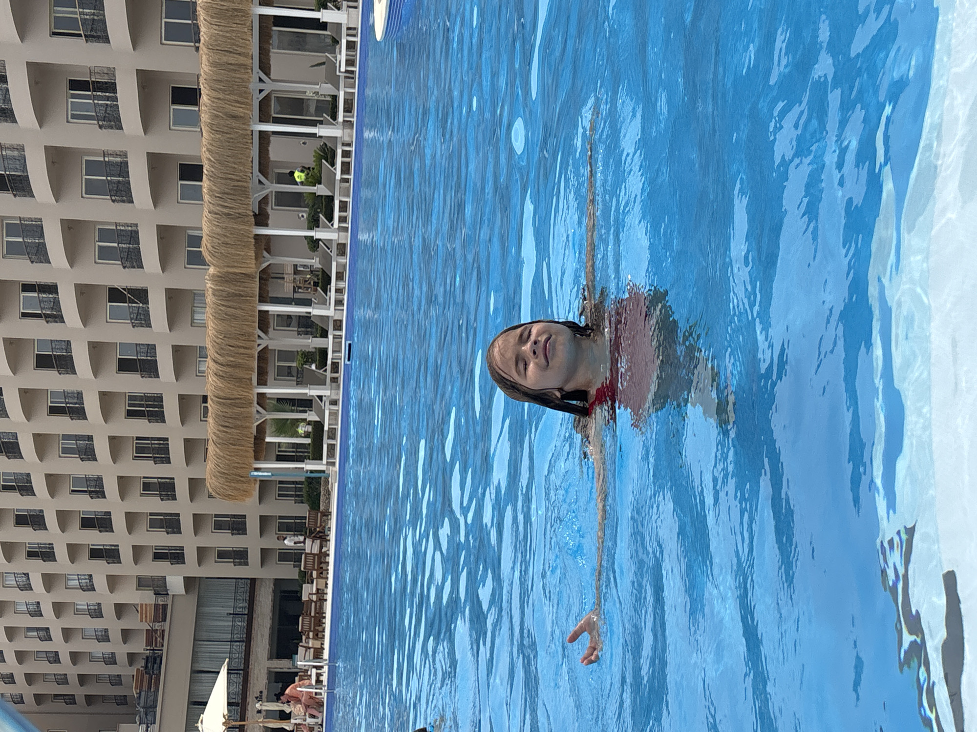 Child floats in hotel pool in Al Ahia', Egypt