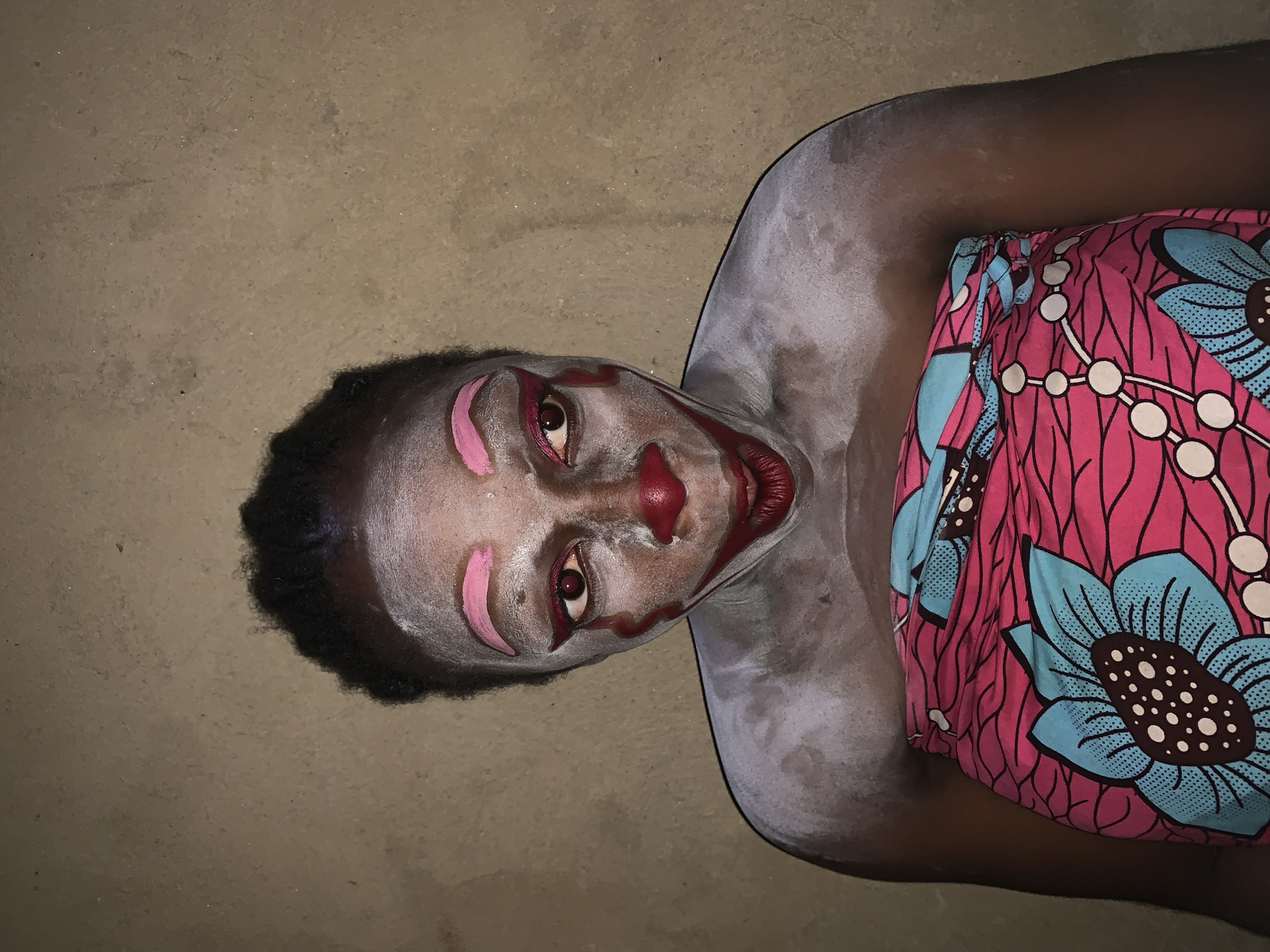 Clown performer balances objects in Nigerian village