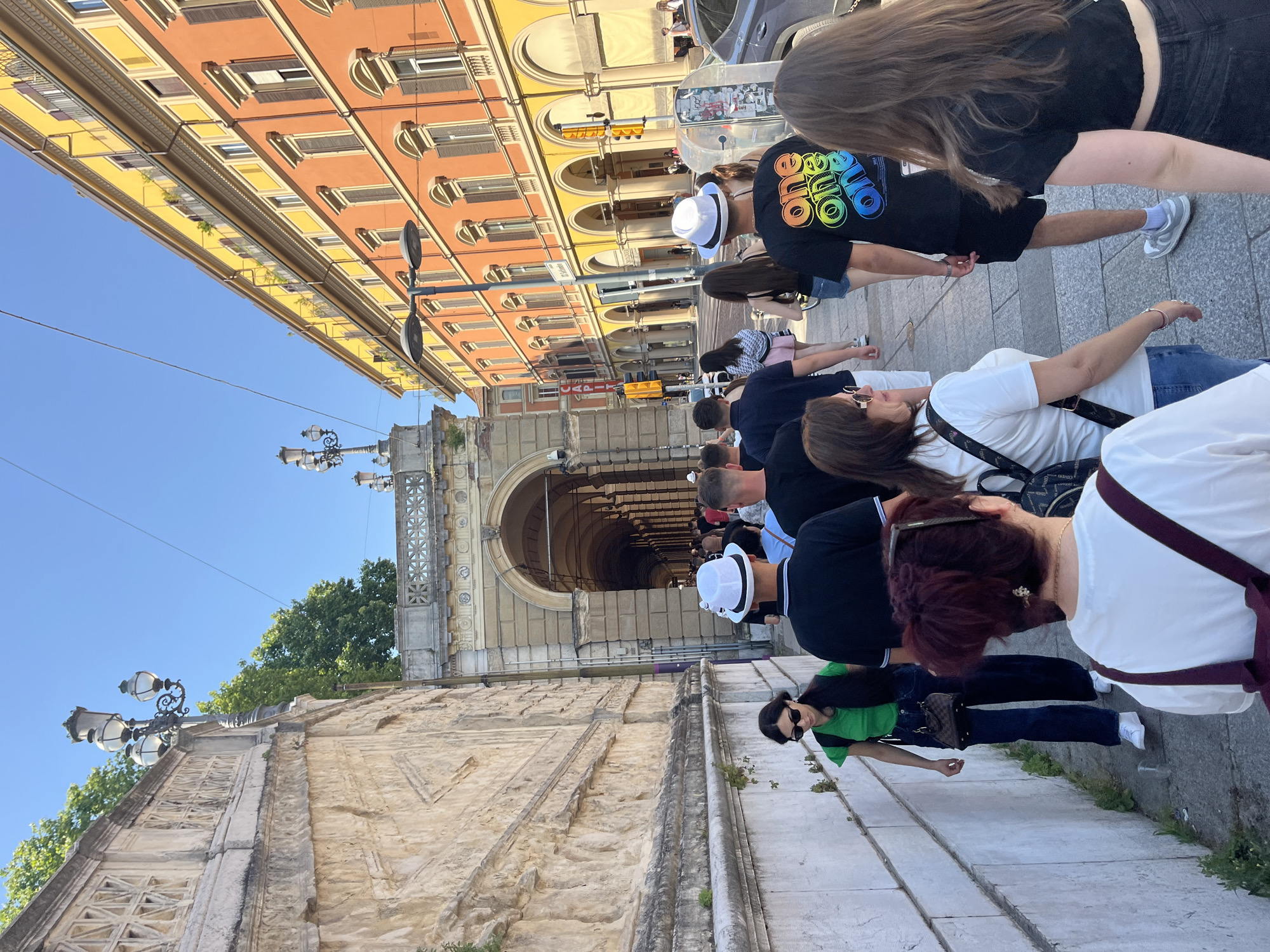 Morning pedestrian activity captured in Bologna's historic porticoes
