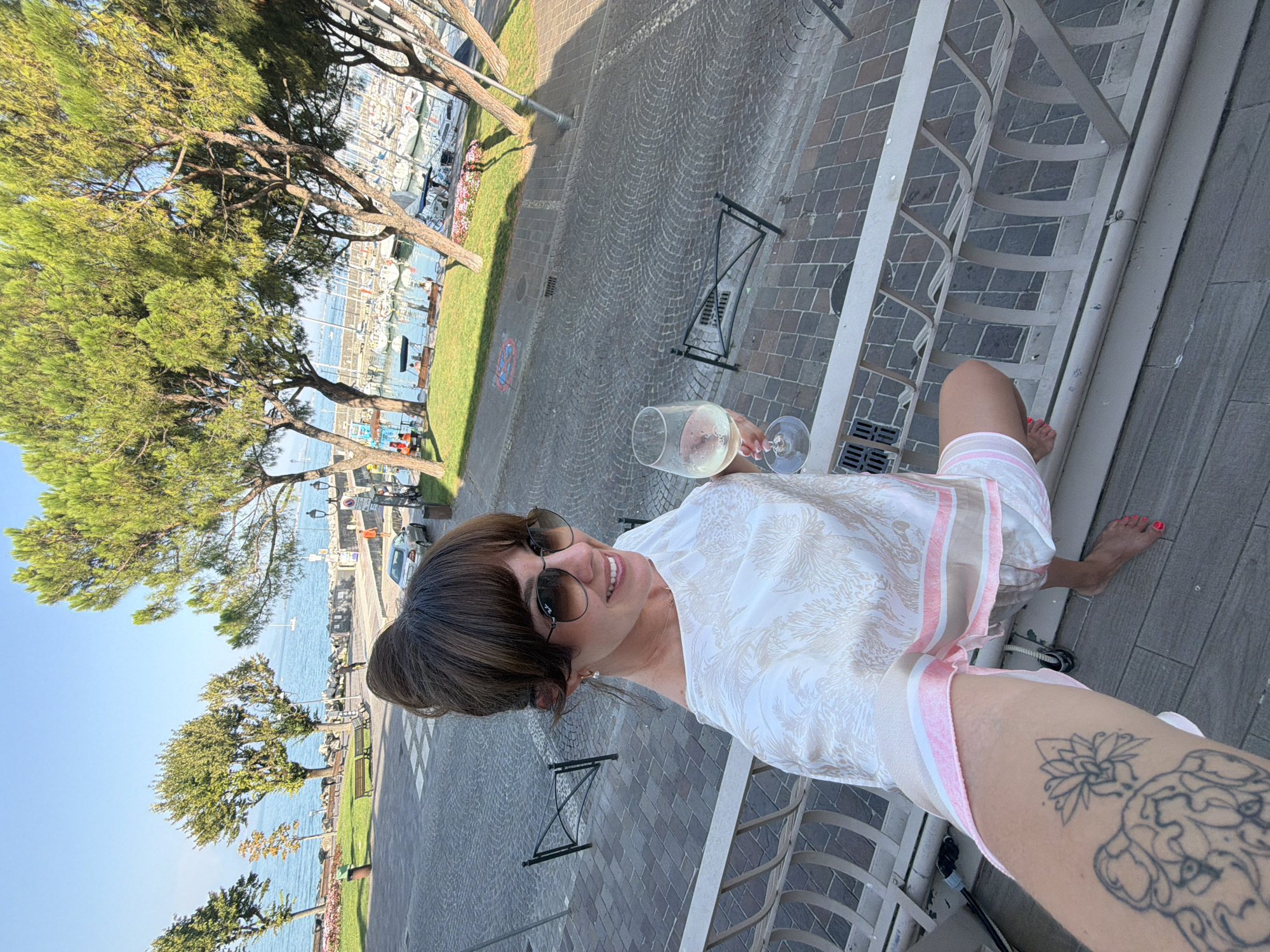 Selfies on a balcony above Desenzano del Garda's harbor