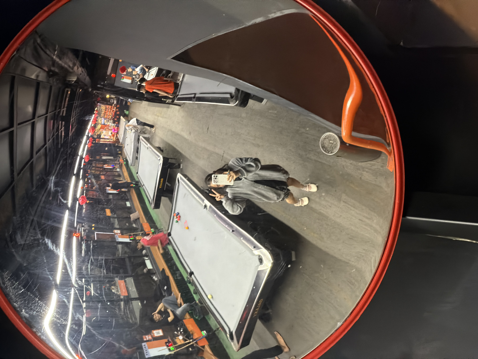 Selfie captured in convex mirror at Đà Nẵng billiard hall