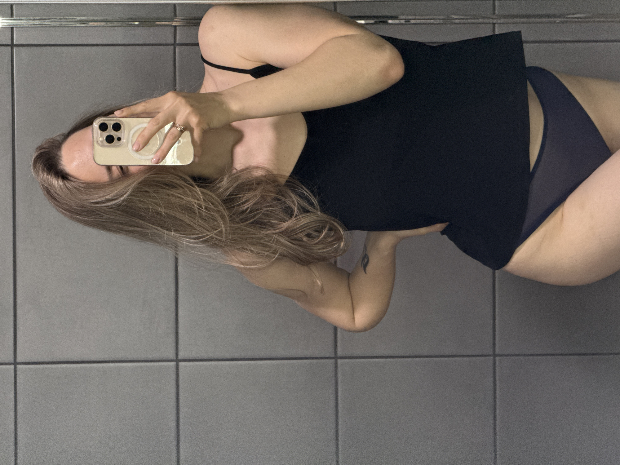 Woman takes selfies in tiled room in Chaikovsky, Russia