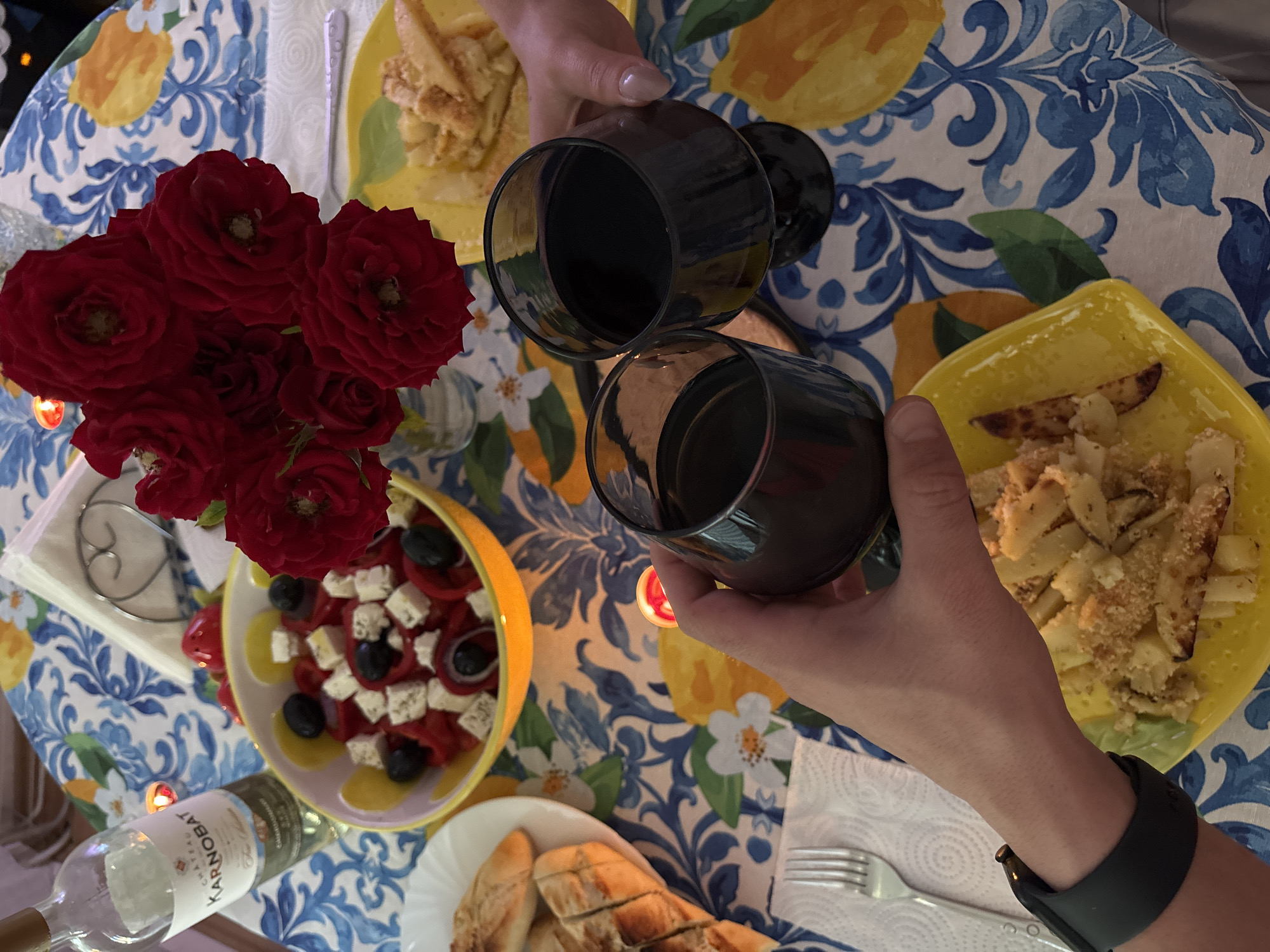 Dinner toast in Veliko Tarnovo with wine and floral tablecloth