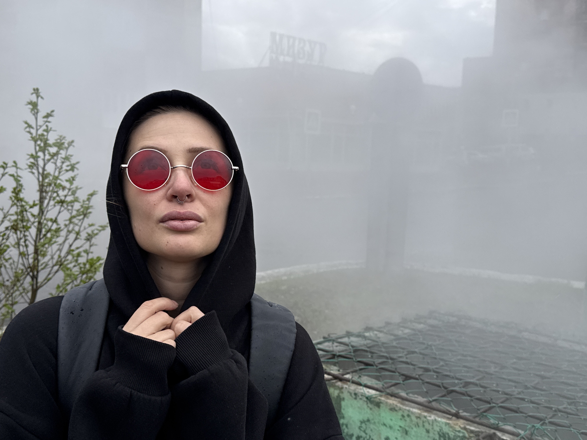 Tourist documents foggy morning walk through industrial Norilsk