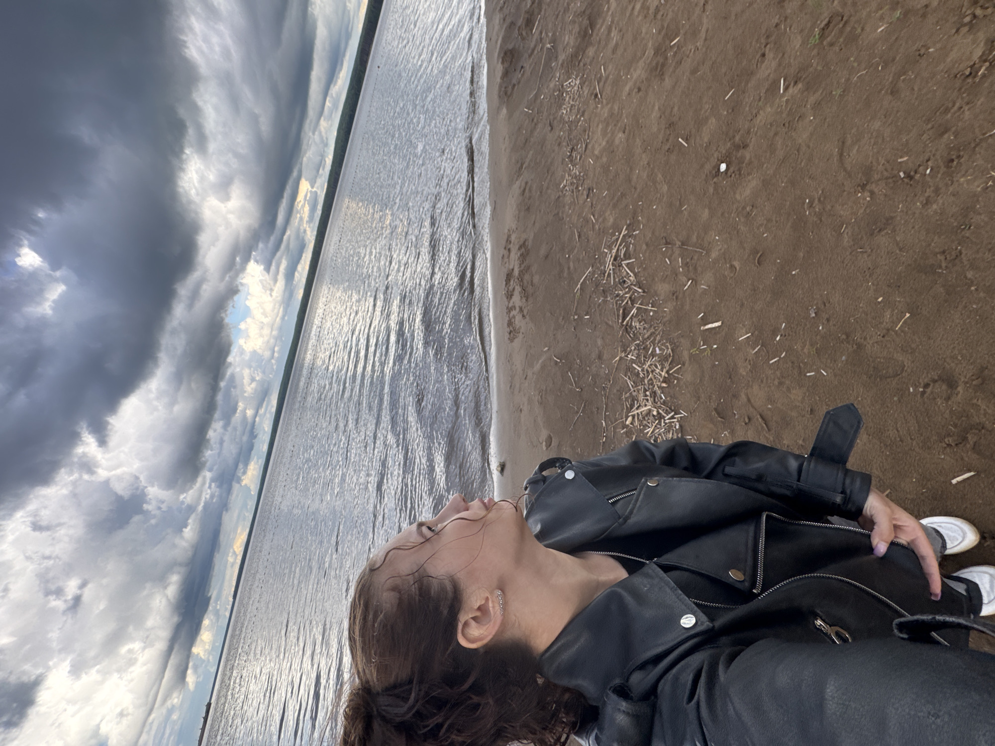 Woman photographed at waterfront in Chaikovsky, Russia during afternoon