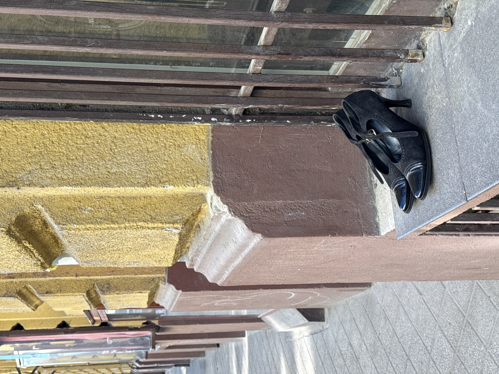 Black heels left on Budapest building ledge