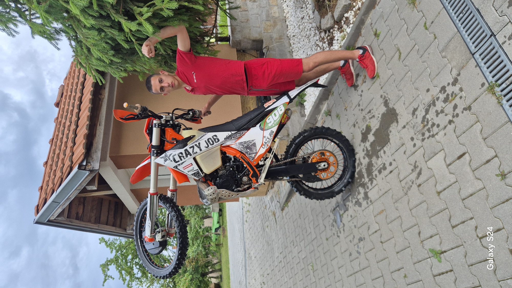 Man rides dirt bike on residential driveway