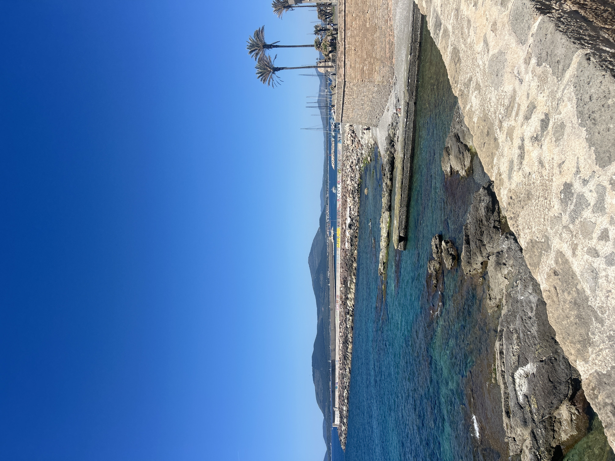 Tourist explores Alghero markets, enjoys gelato on sunny Italian morning
