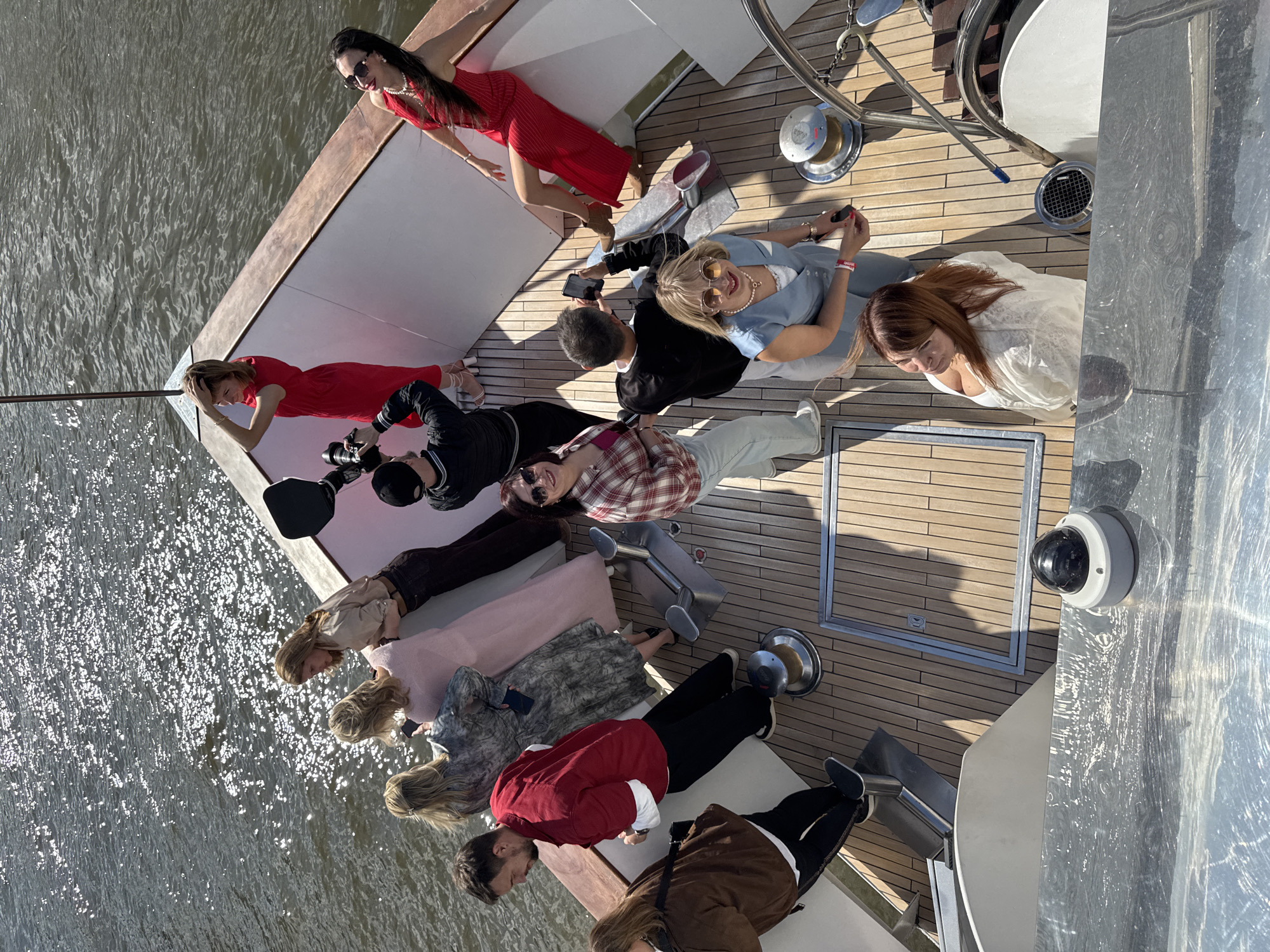 Yacht gathering with photographer captures two women in red