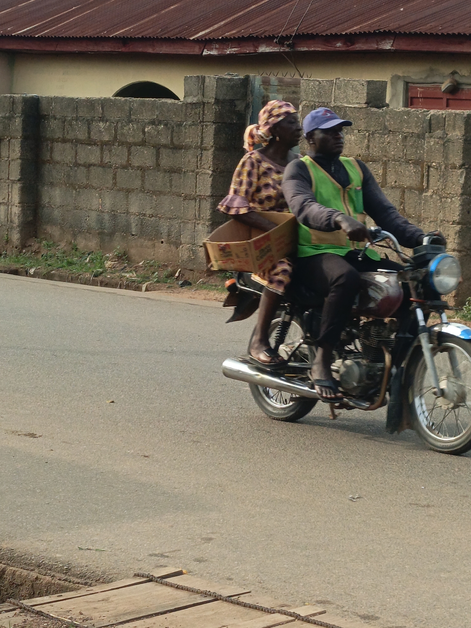 Motorcycle riders photographed on road in Akwanga, Nigeria