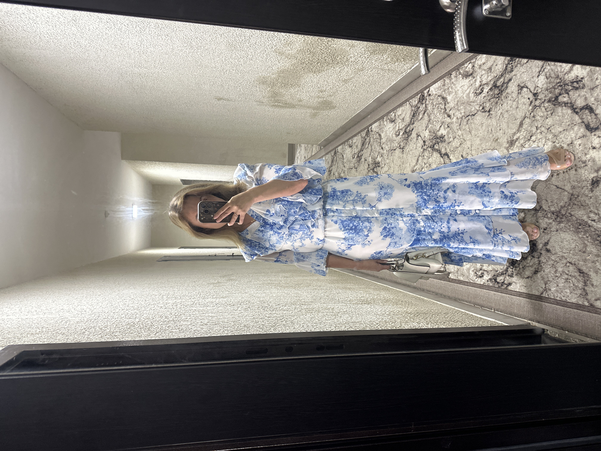 Mirror selfie in a hallway, dressed up in floral