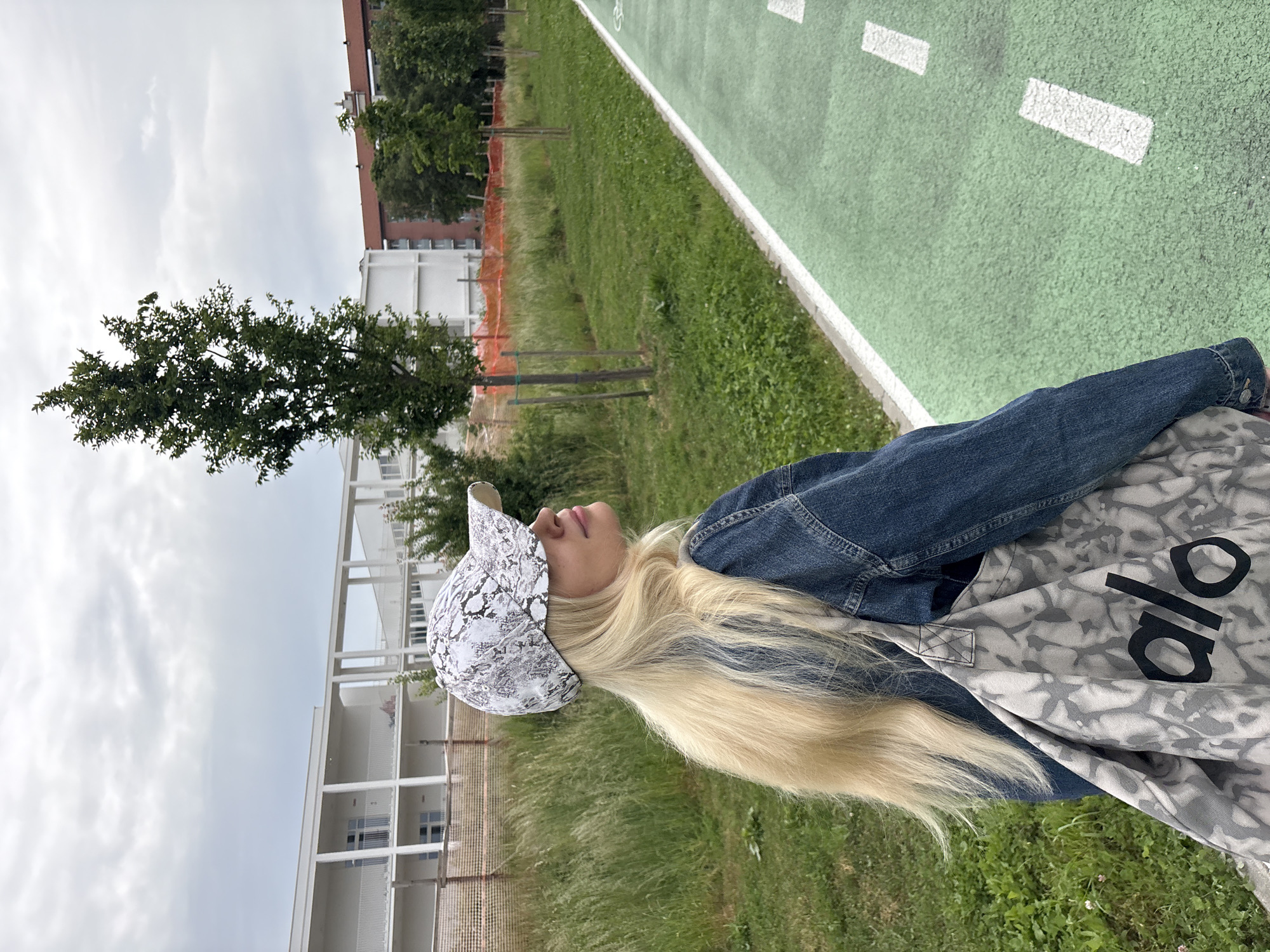 Woman walks cycle track with smartphone in Novate Milanese