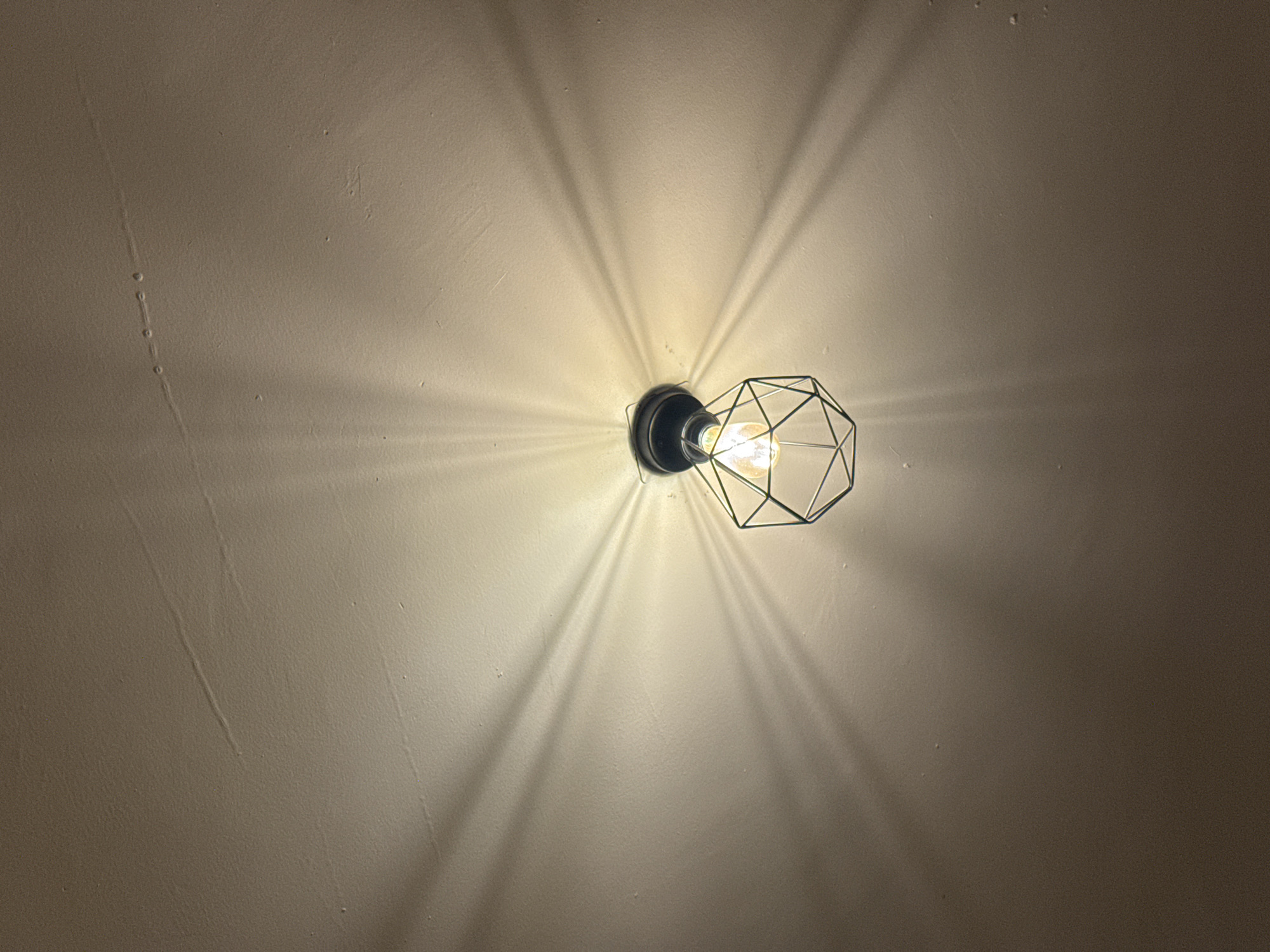 Wall-mounted cage light fixture observed in Oaxaca City