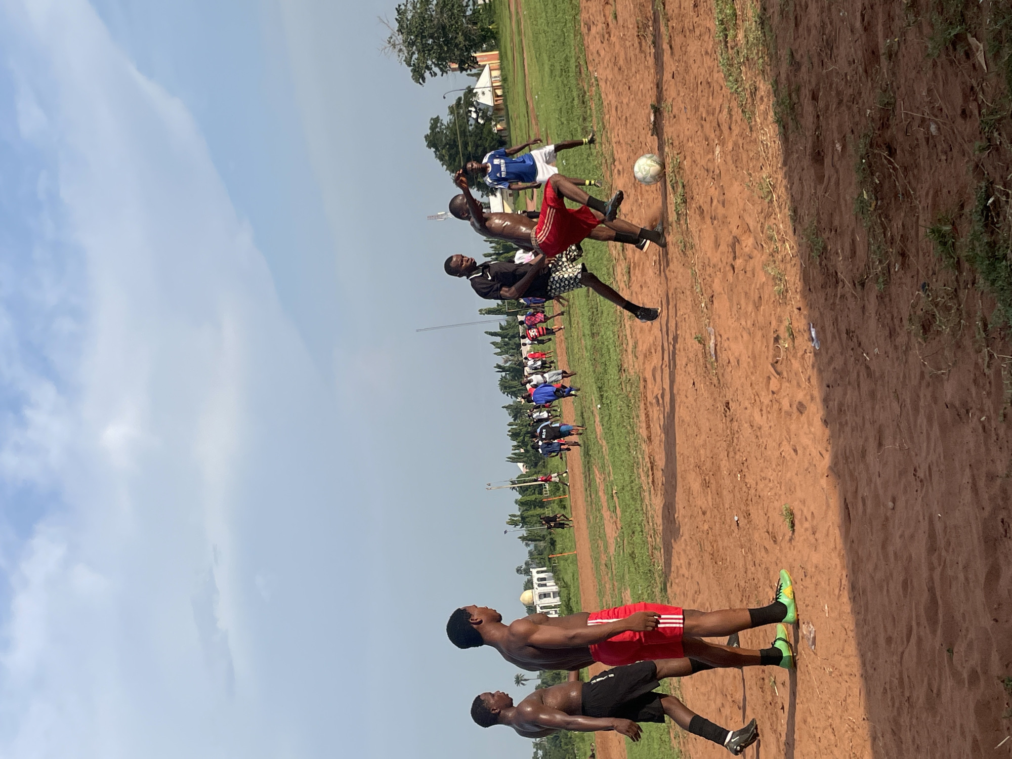Casual soccer match on dirt field in Ogbogbo, Nigeria
