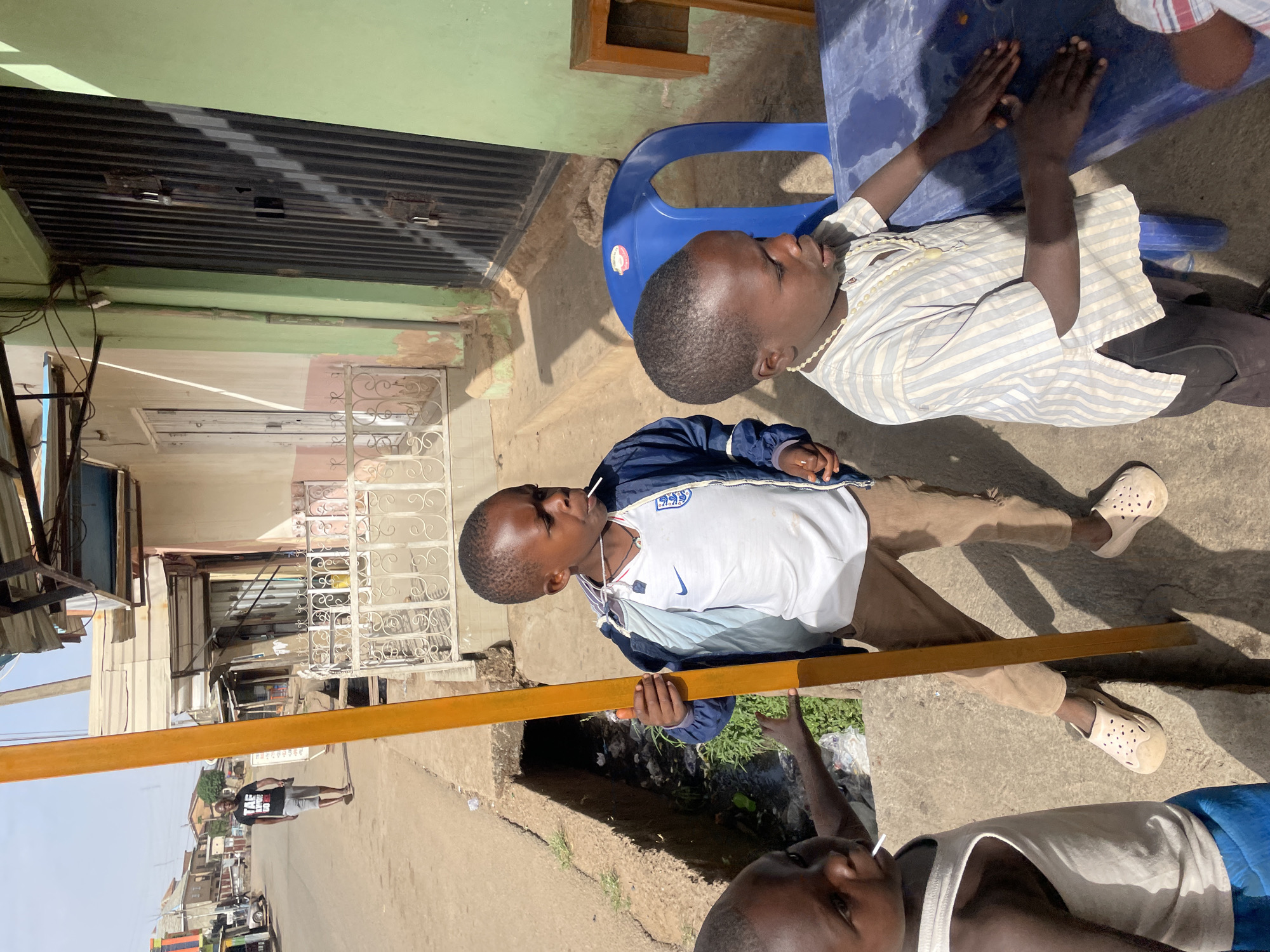 Boys gather at outdoor table in Jos, Nigeria