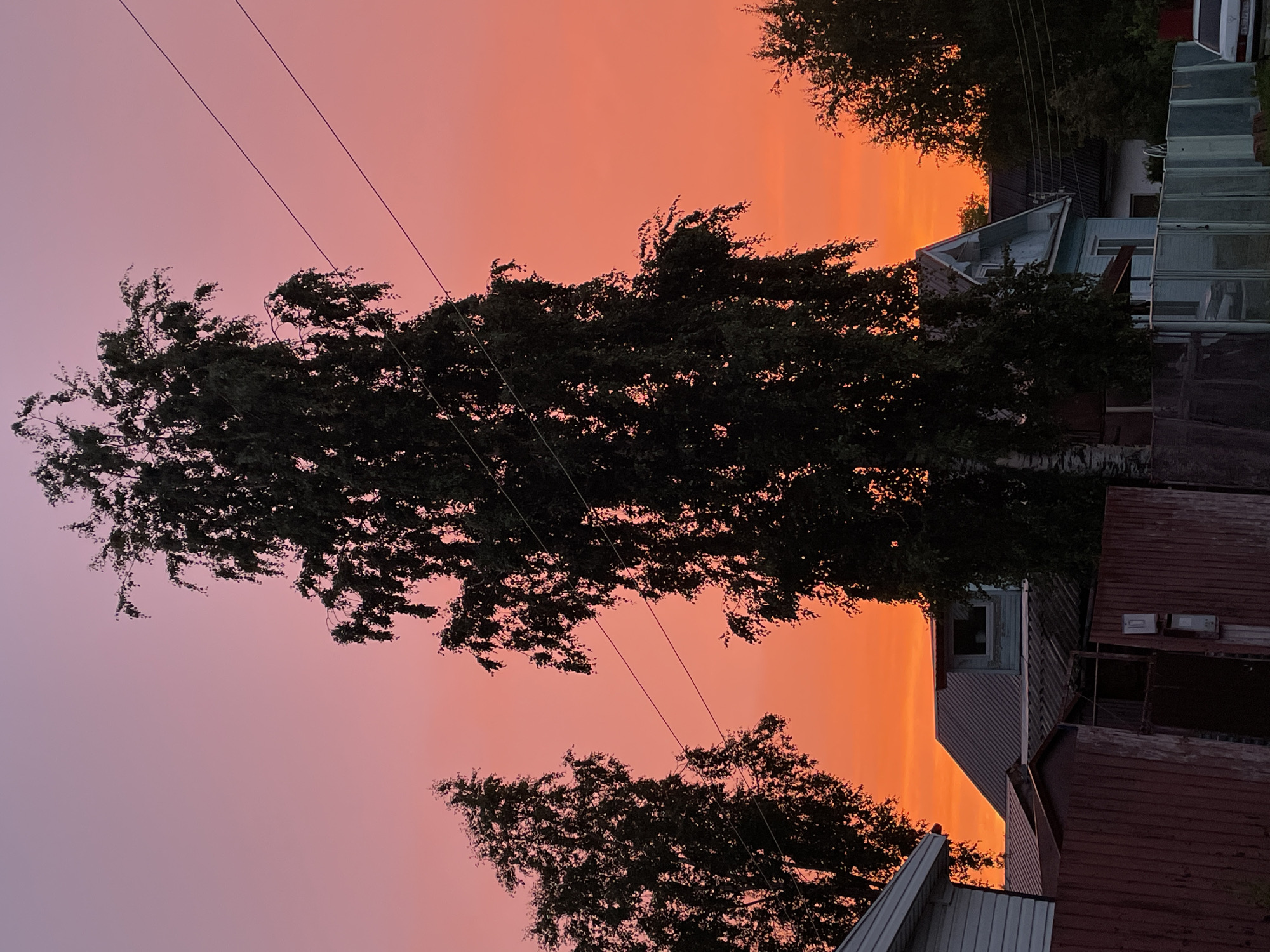 Fiery summer sunset over Severodvinsk streets and rooftops