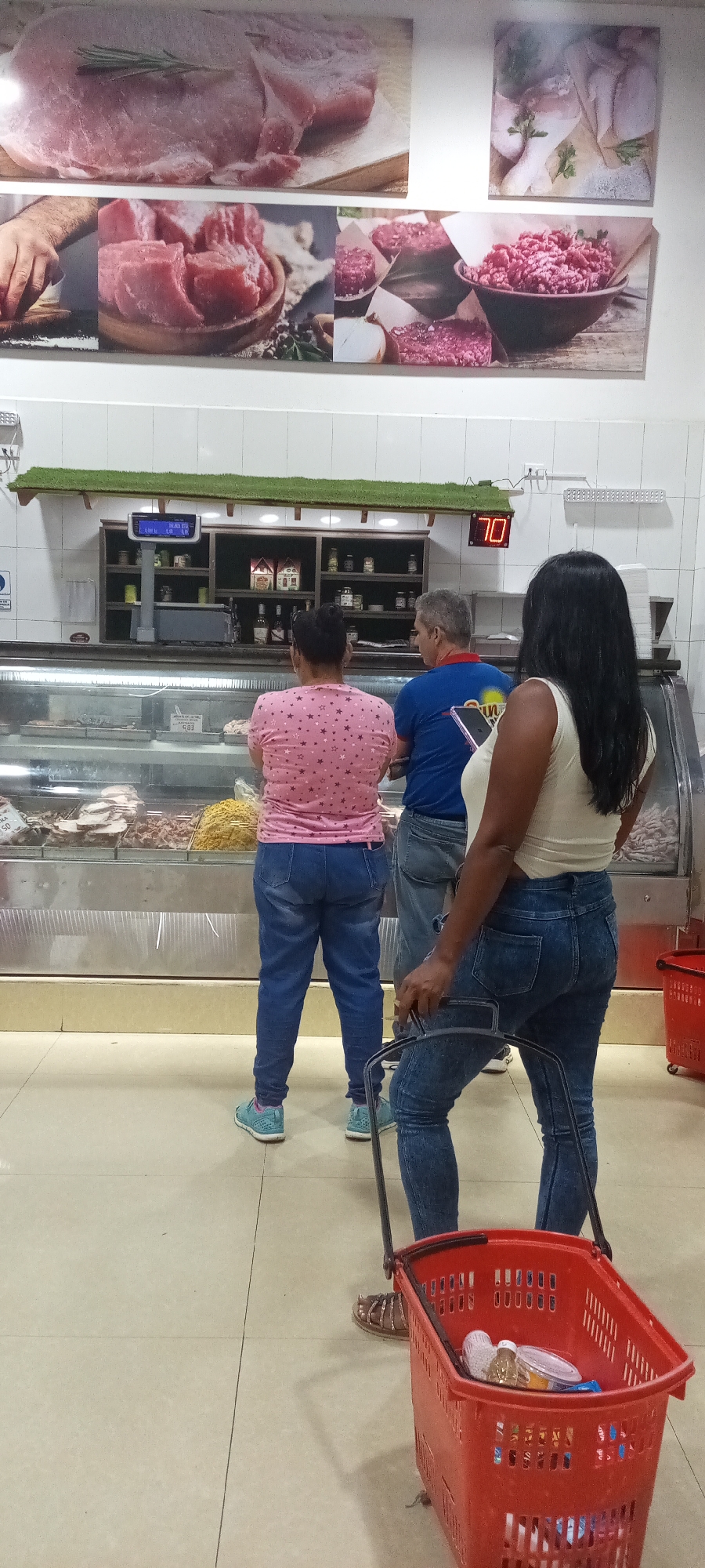 Evening shoppers visit Sun Market meat counter, store operations