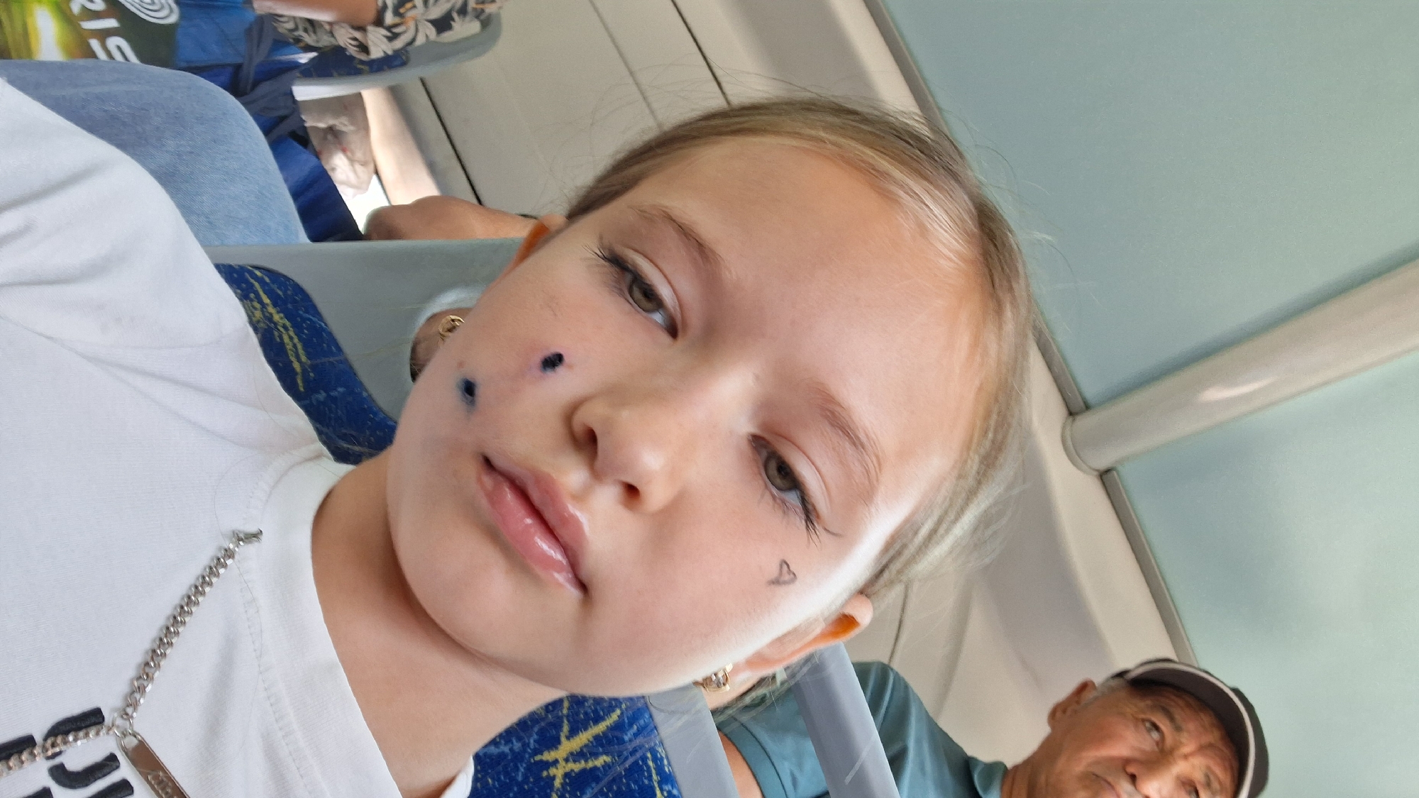 Selfie series on a Semey bus, silver necklace and cheek marks