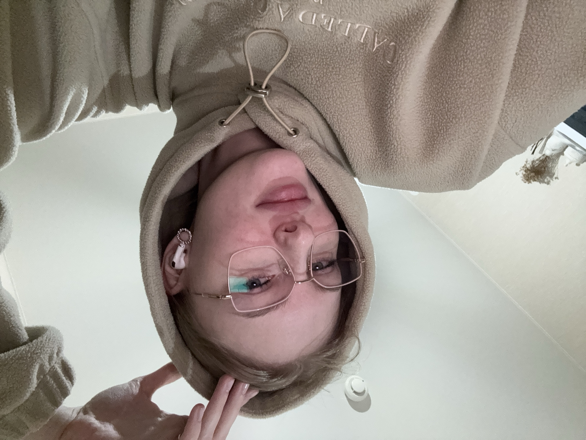 Woman takes selfies in beige hoodie in Perm