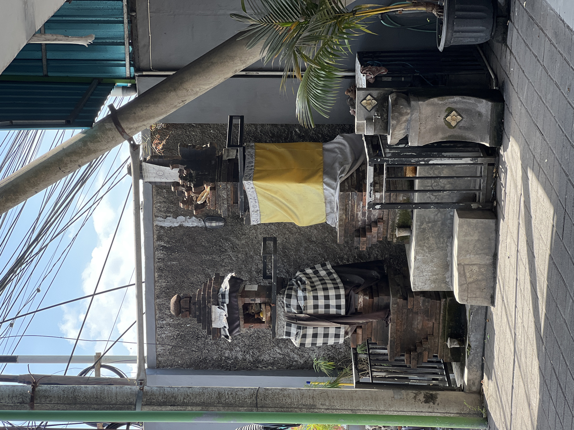 Everyday street life in Denpasar, scooters and shrines.