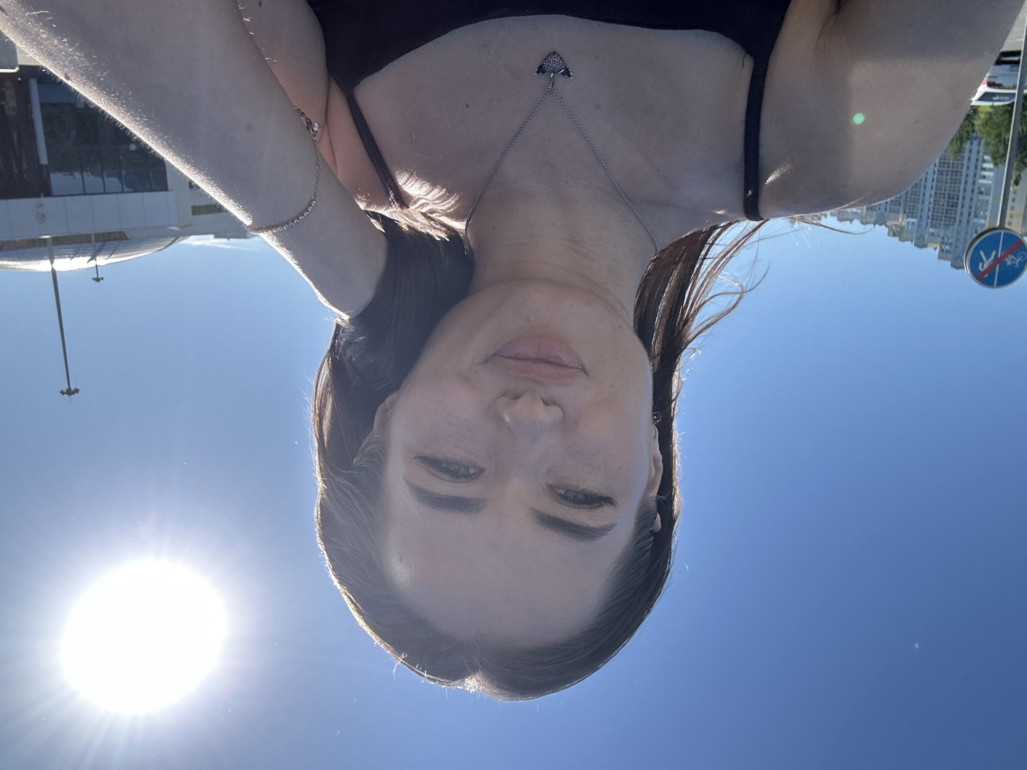 Sunny-day selfies outside a modern building with a red roof
