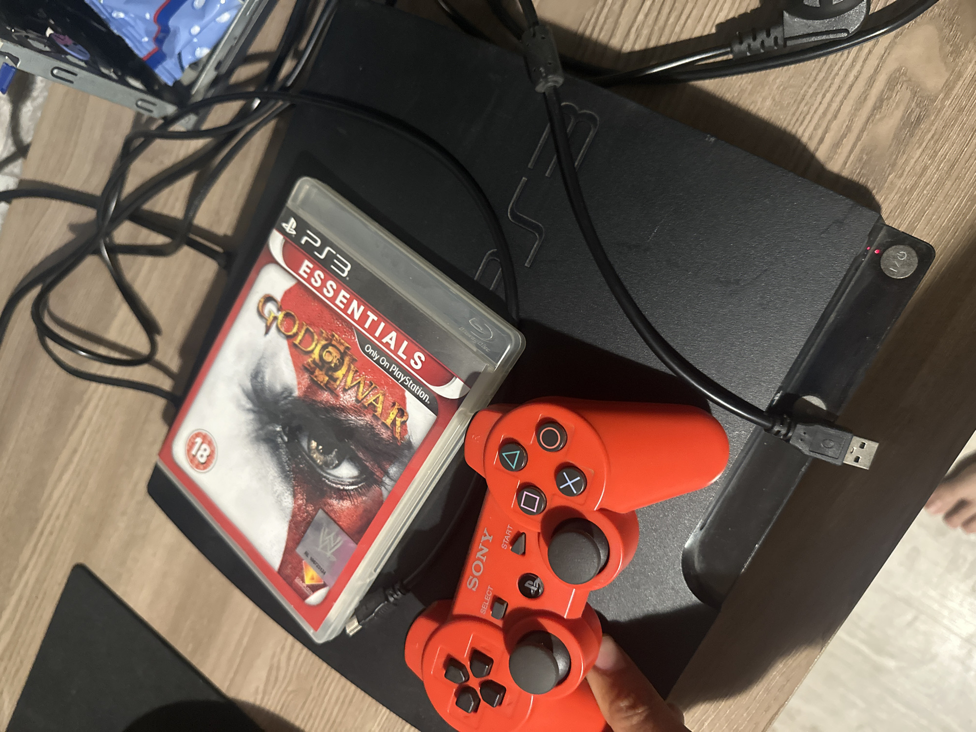 PlayStation 3 gaming setup documented with controller and game