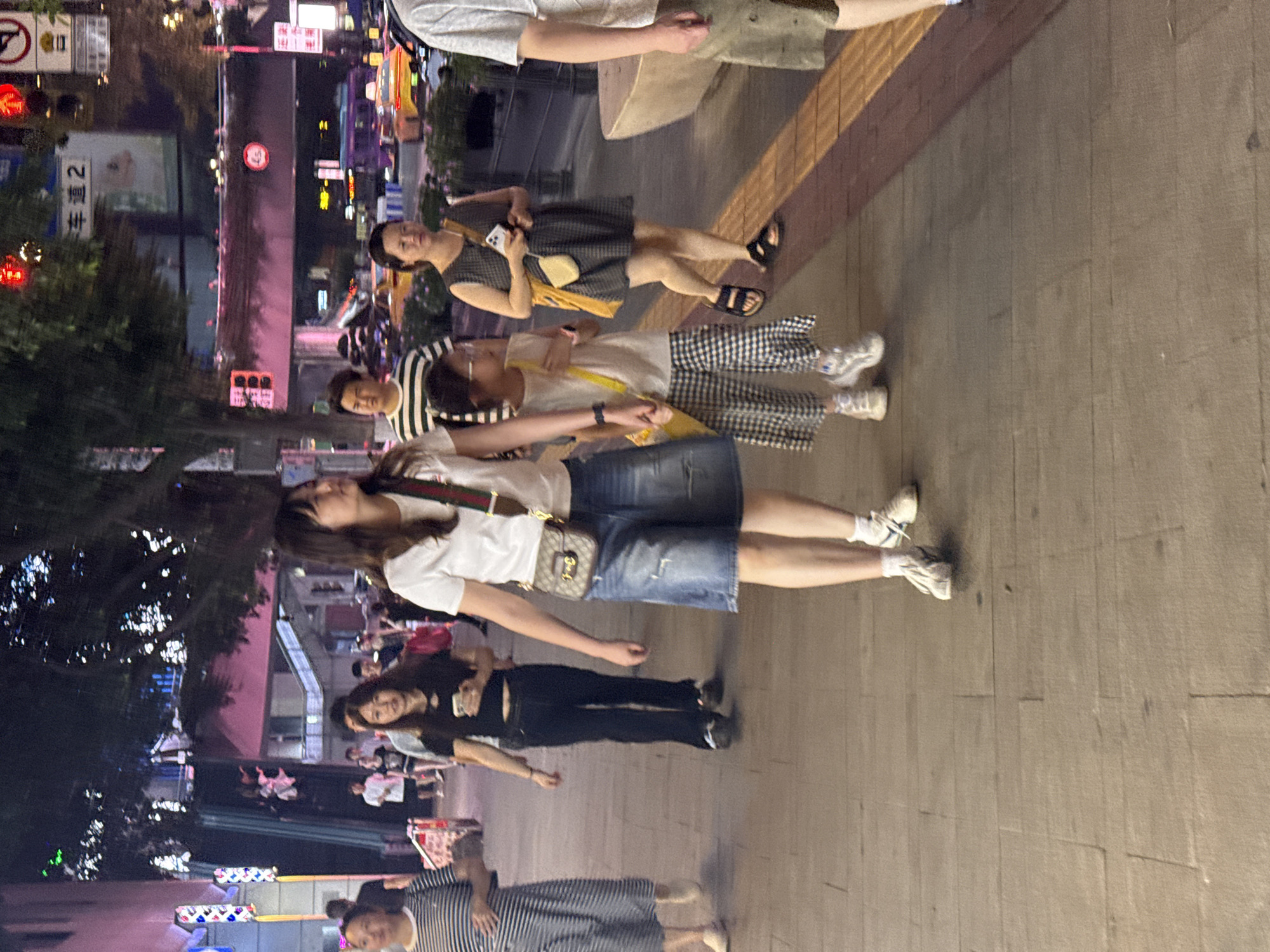 Evening foot traffic on a neon-lit Chongqing pedestrian street