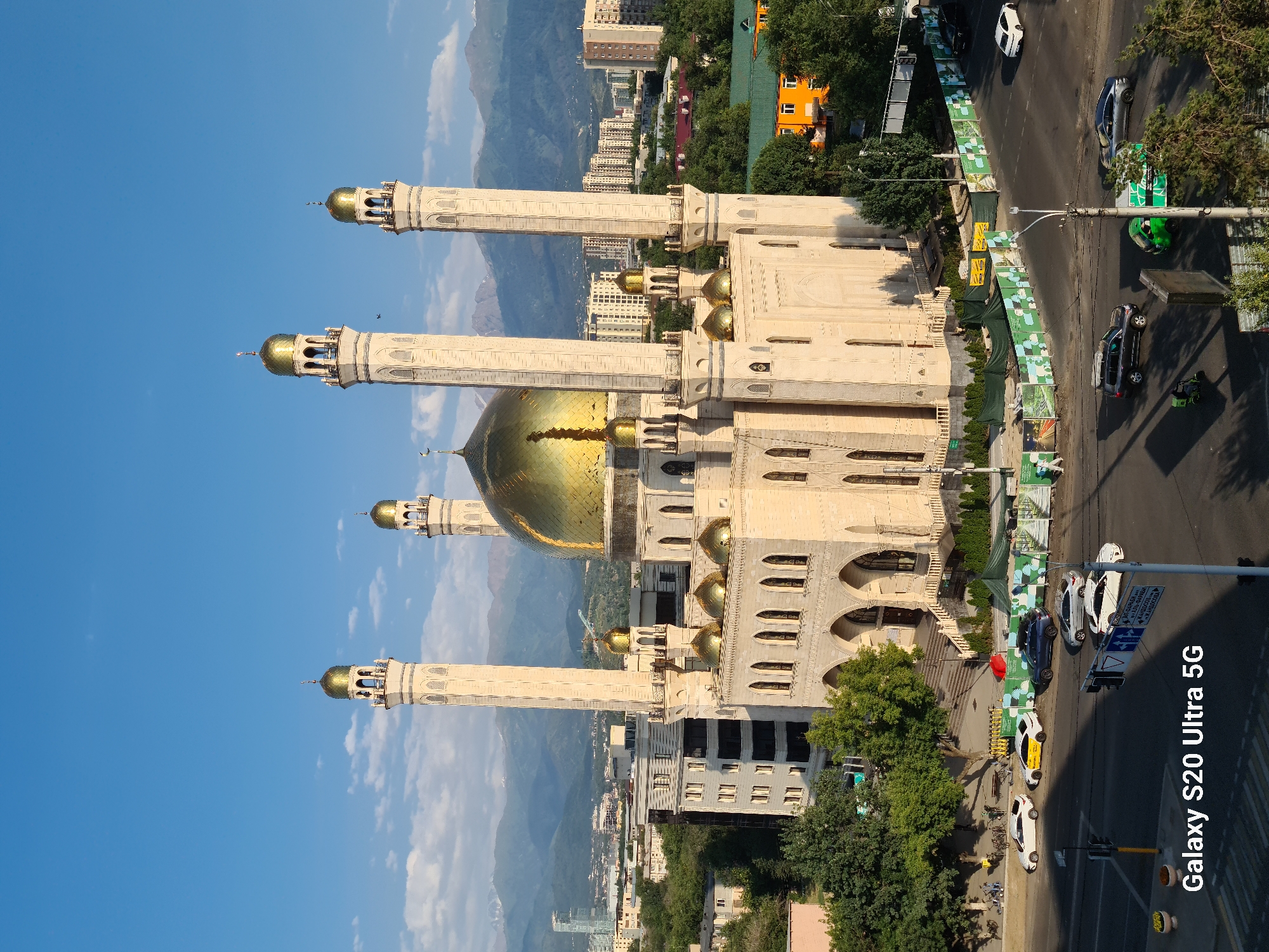Almaty's Central Mosque and city skyline at golden hour