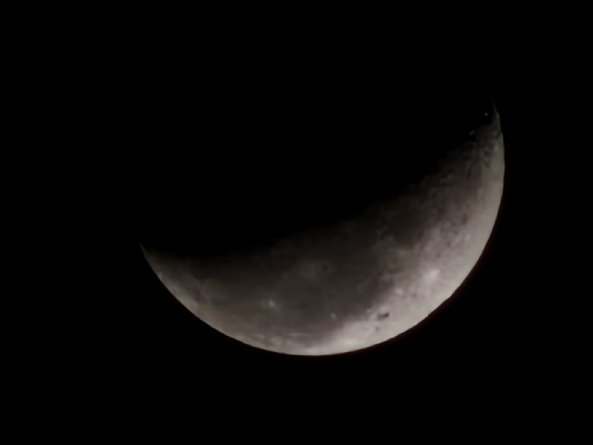 Crescent moon photographed over Esch-sur-Alzette at night