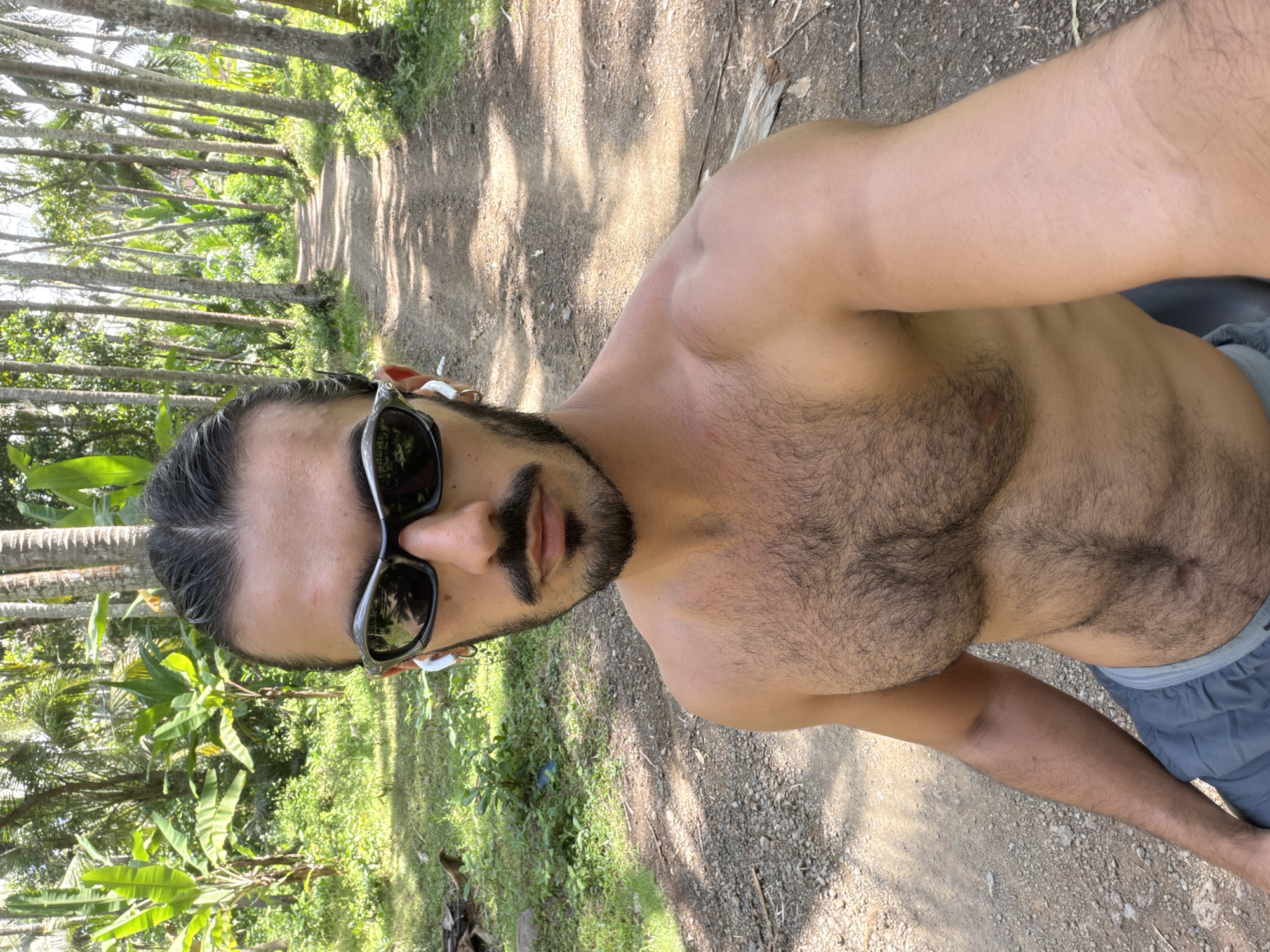 Man takes selfie on rural path in Karangasem