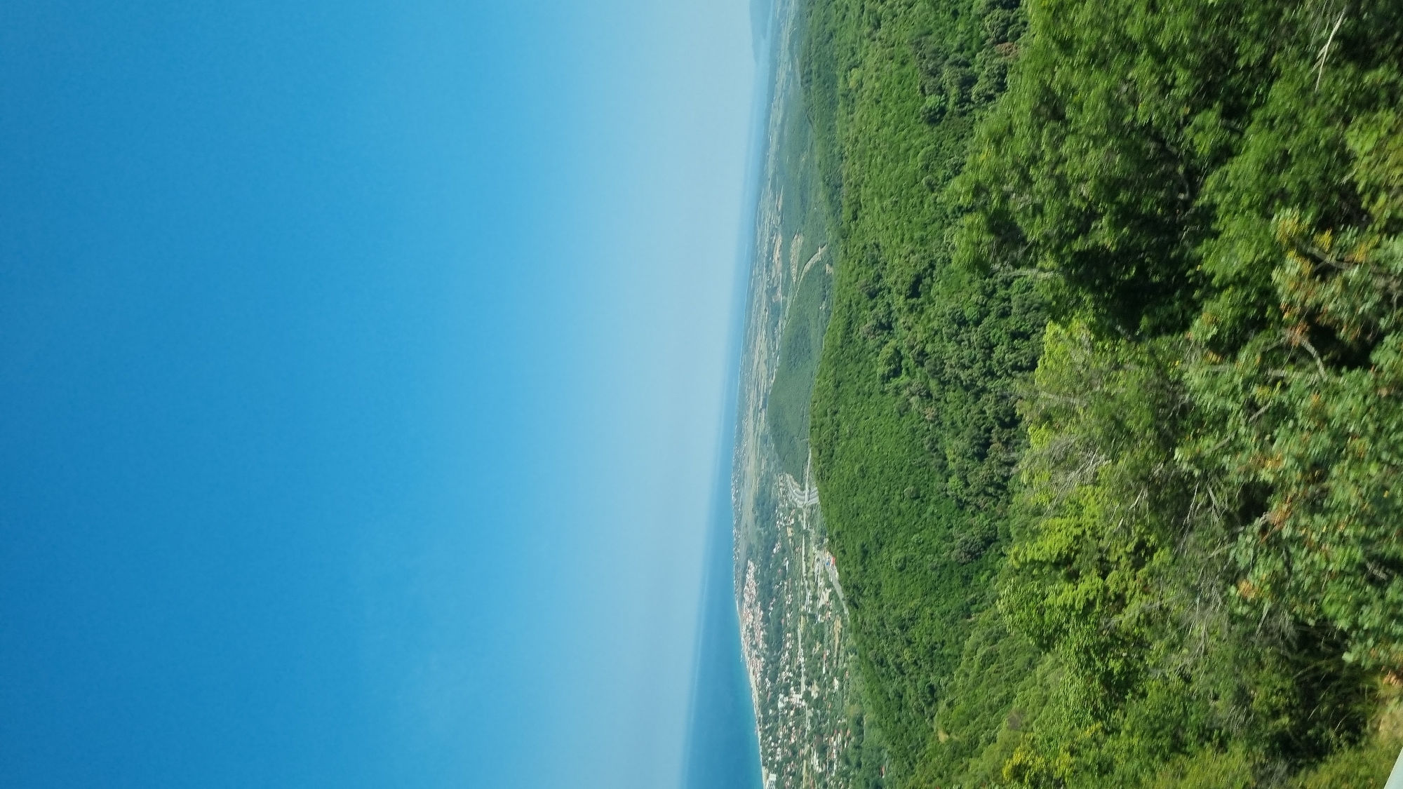 Winding through forested hills above the Greek coast